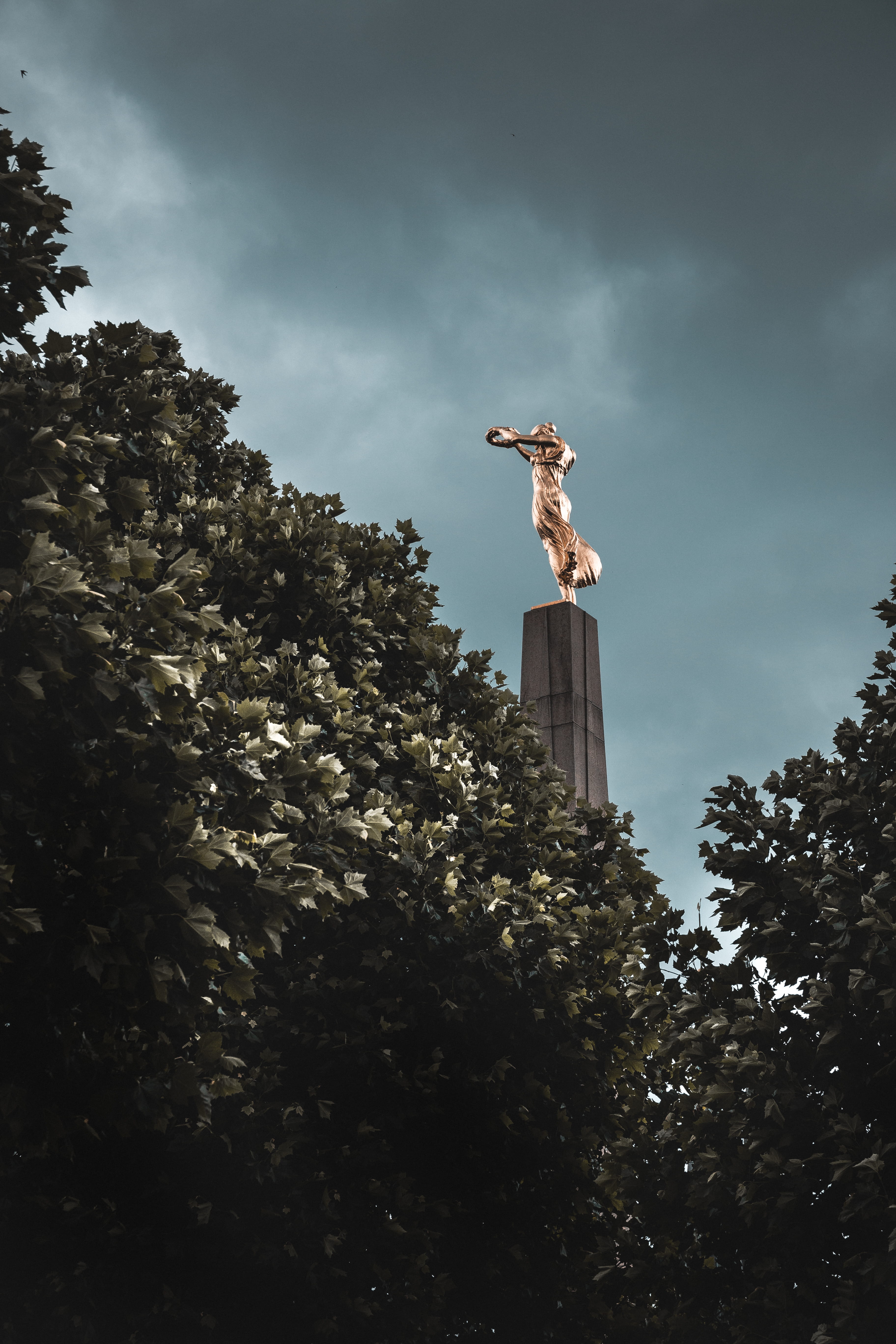 obelisk, city, art and craft, one person, low, leisure activity, statue, growth, human representation, photography, art, 5K, sky, column, building, sculpture, Phone HD Wallpaper