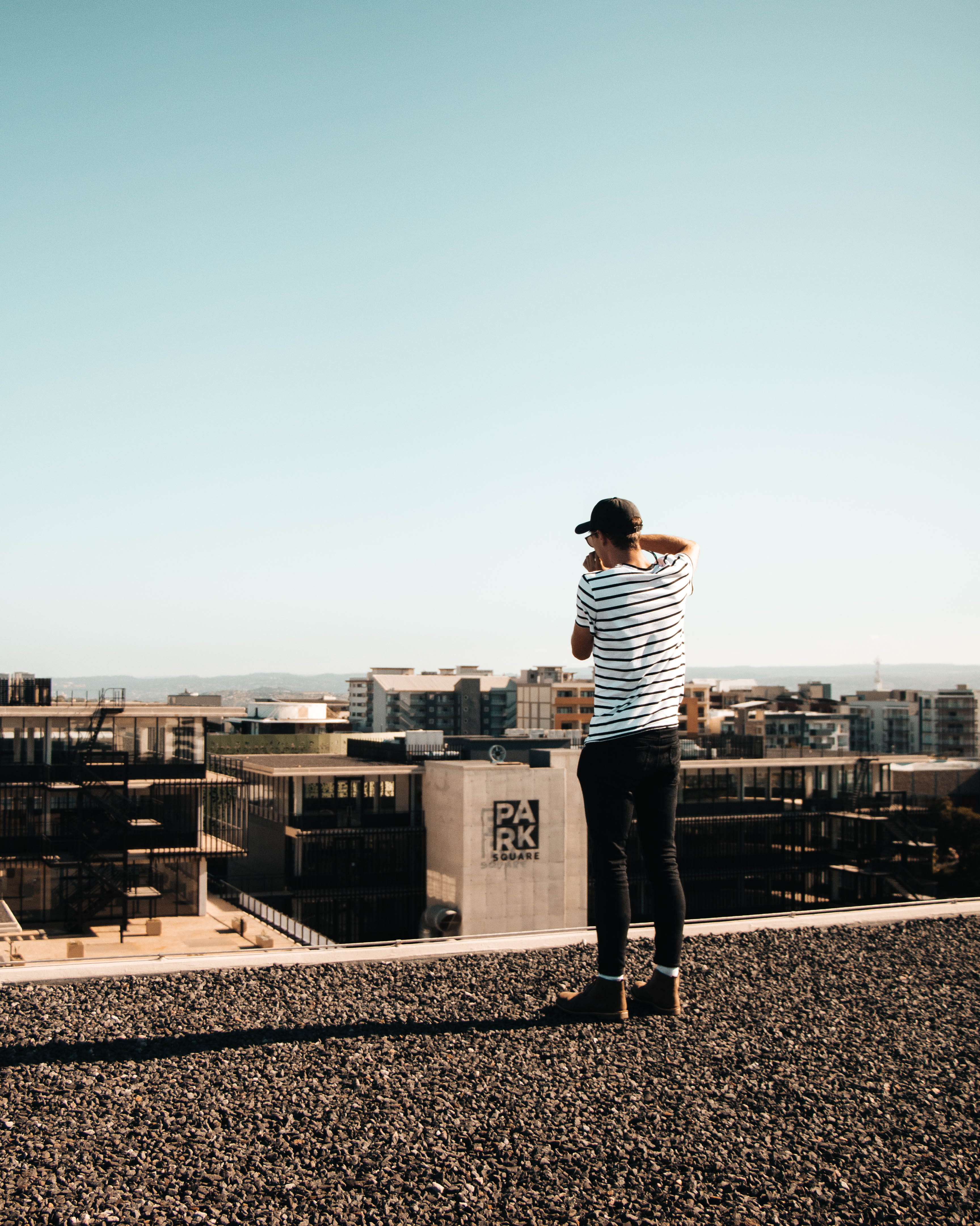 built structure, city, sky, sunlight, full length, one person, men, day, tarmac, south africa, rear view, nature, building exterior, road, spire, dirt road, Phone HD Wallpaper
