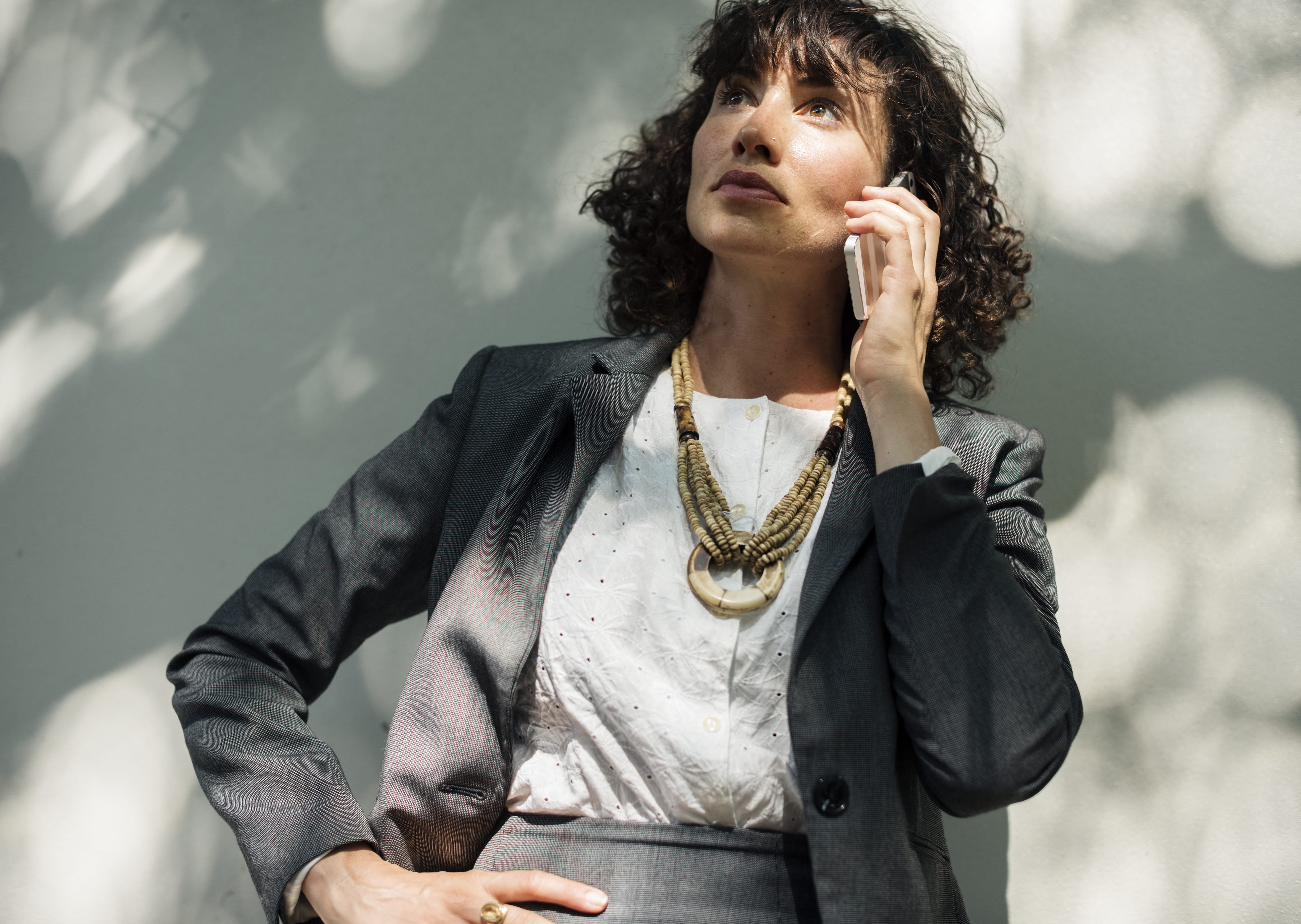 one person, outdoors, wall, standing, fashion, lifestyles, style, talk, looking up, corporate attire, hairstyle, cellphone, portrait, looking, beautiful woman, HD Wallpaper