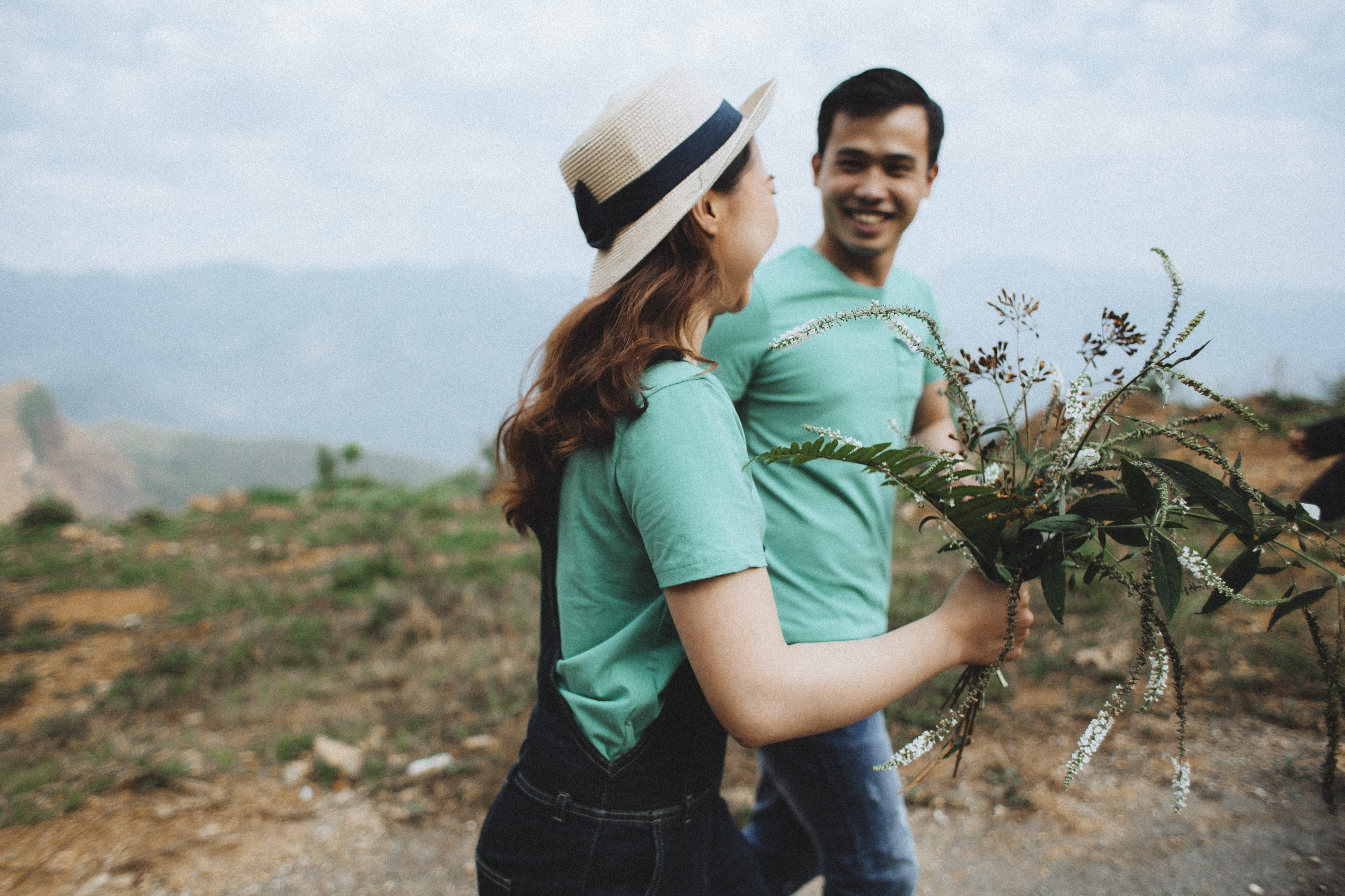 holding, hat, man and woman, field, green, three quarter length, women, adults Only, plant, two People, cheerful, standing, togetherness, hiking, people, HD Wallpaper