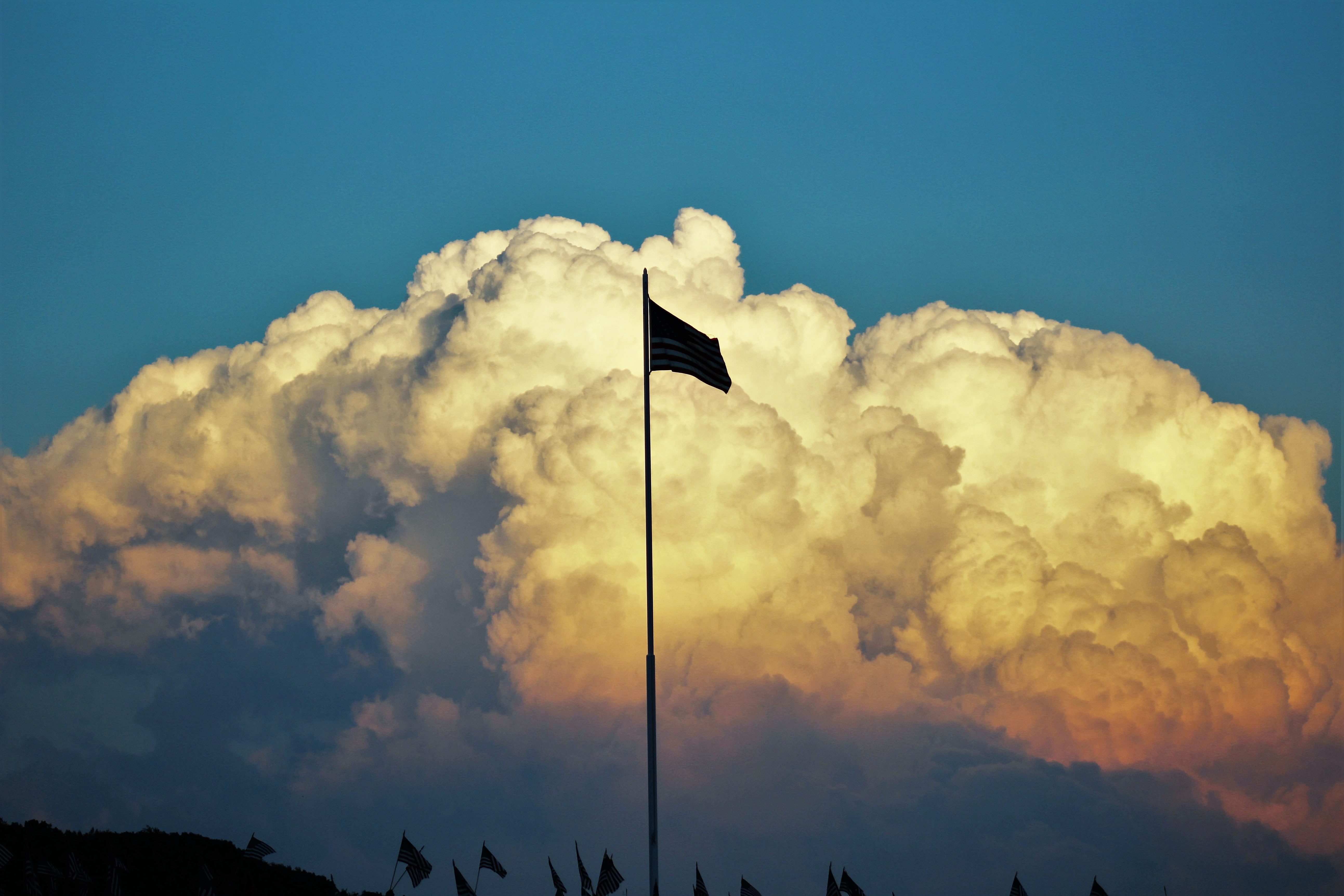 5K, meteorology, patriotism, cloud, flag, cloud - sky, sunlight, tranquil scene, tranquility, blue, flagpole, communication, day, nature, wind, outdoors, HD Wallpaper