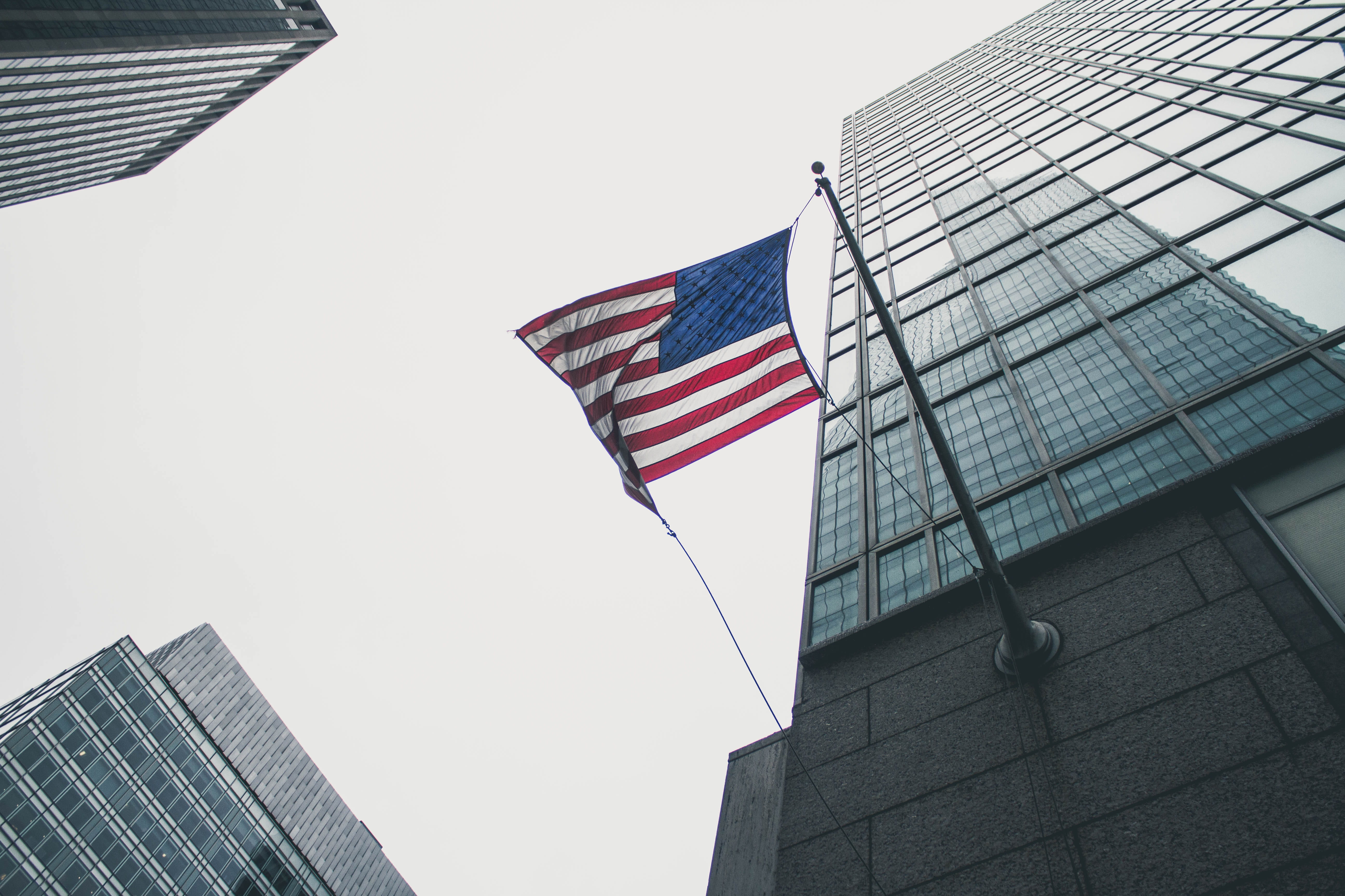 low angle view, skies, sky, tall - high, 5K, patriotism, america, flag of U.S.A., skyscraper, clear sky, striped, office, american Flag, gray, wind, uSA, HD Wallpaper