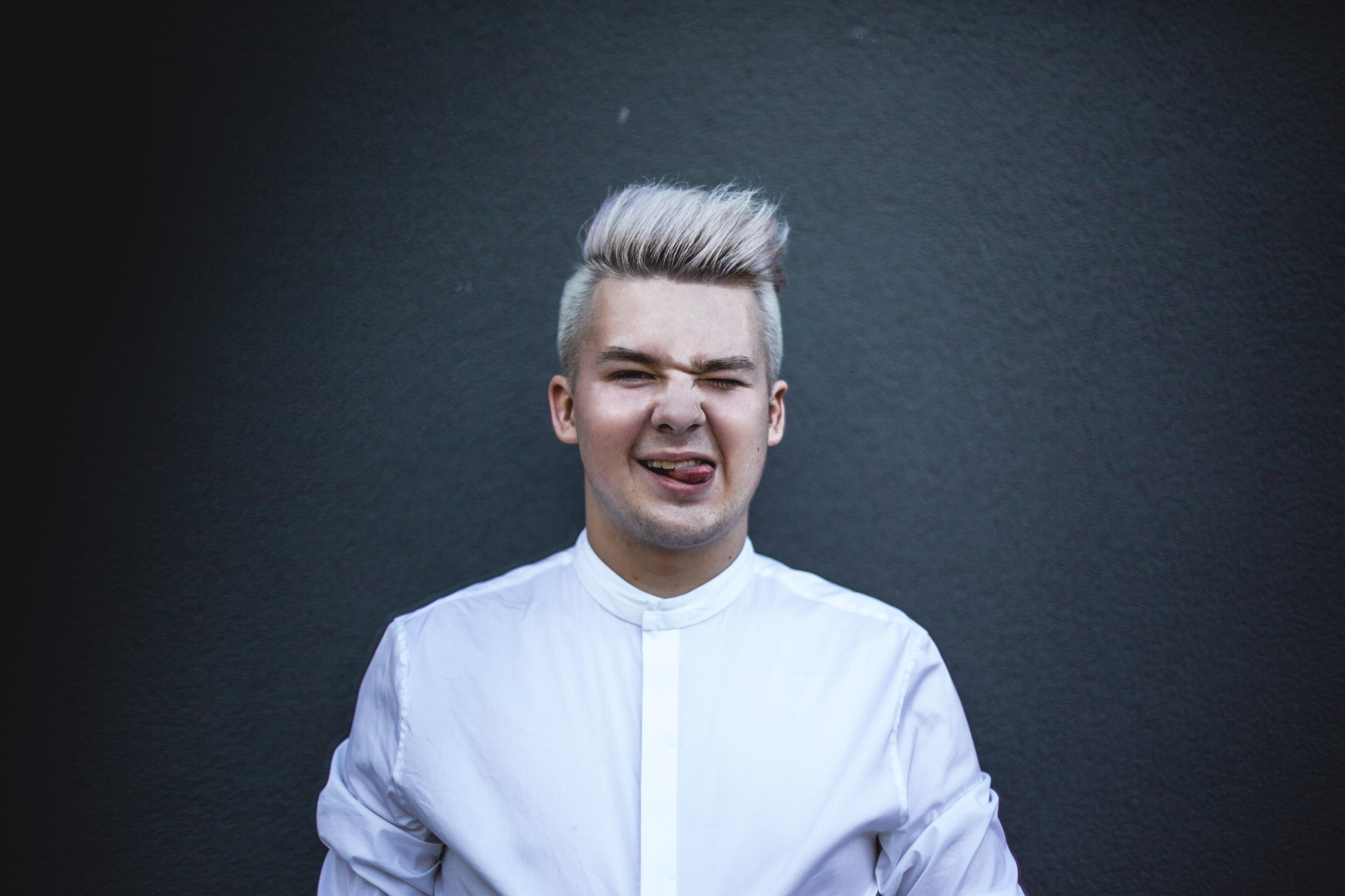adult, smiling, facial expression, indoors, 5K, headshot, man, person, blonde, wearing, standing, top, confidence, looking at camera, Gay Pride, gray background, HD Wallpaper