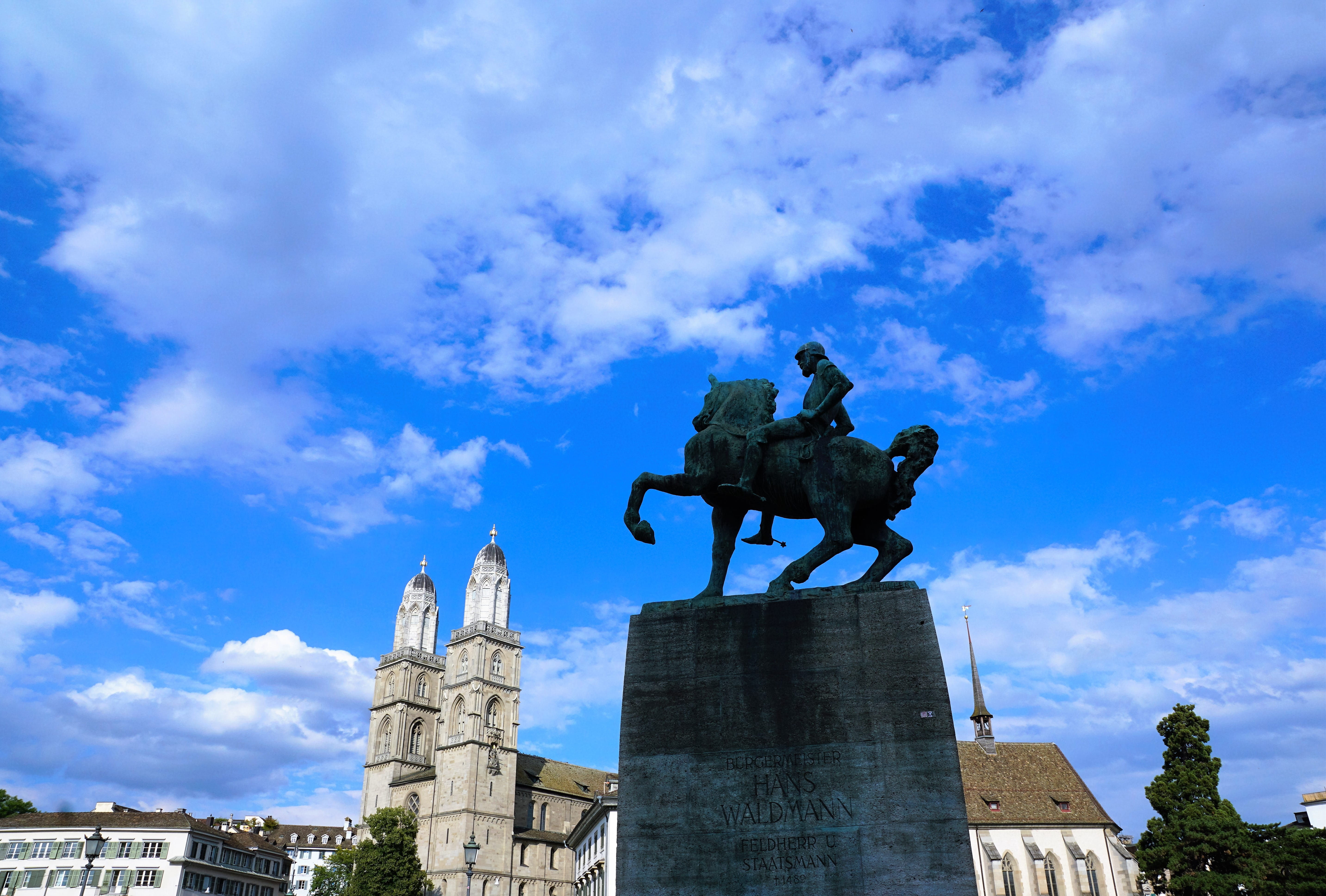 monument, outdoors, creativity, male likeness, statue, figure, blue, 5K, no people, low angle view, king - royal person, cloud - sky, zurich, waldmann, HD Wallpaper