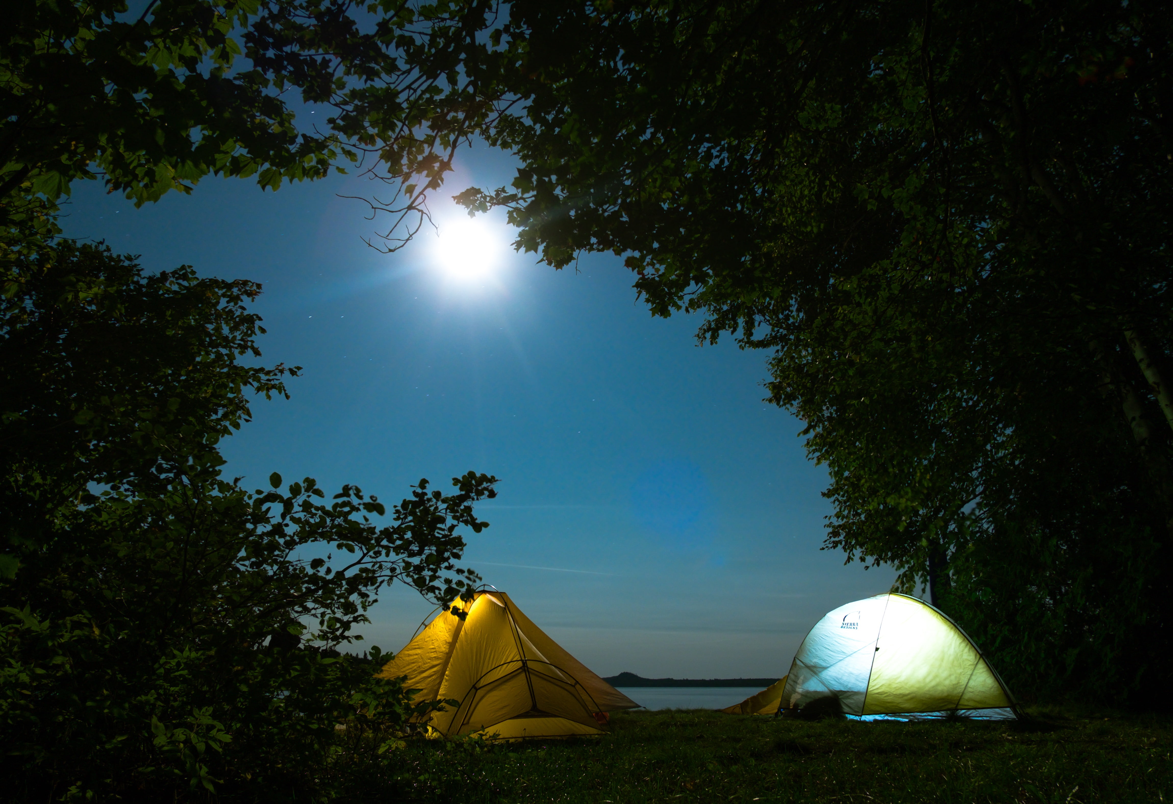 sun, lens flare, mountain, tranquility, night, scenics - nature, outdoors, wilderness Area, grass, yellow, travel Destinations, tents, growth, blue, hiking, HD Wallpaper