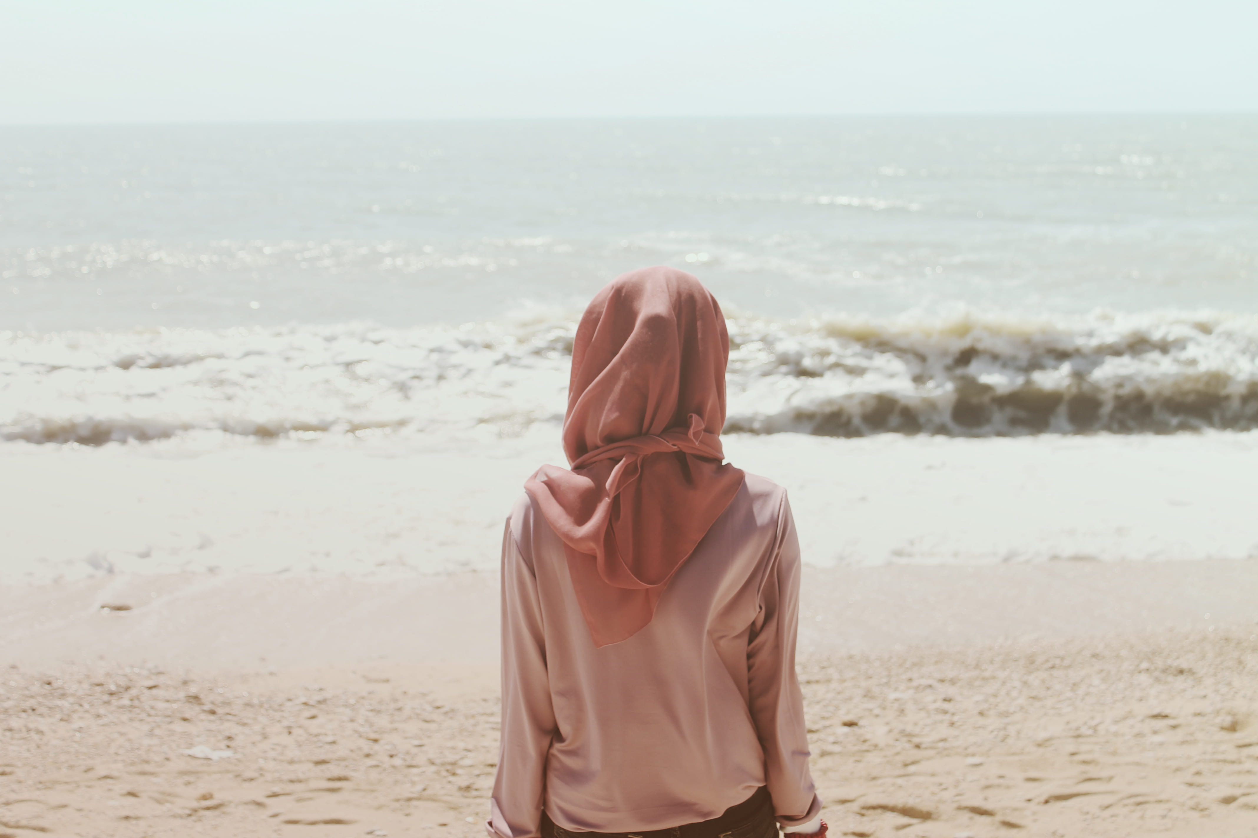 head scarf, waist up, waves, one person, sea, staring, sitting, looking, thoughtful, lifestyles, real people, water, kerchief, splashing, rear view, adult, HD Wallpaper