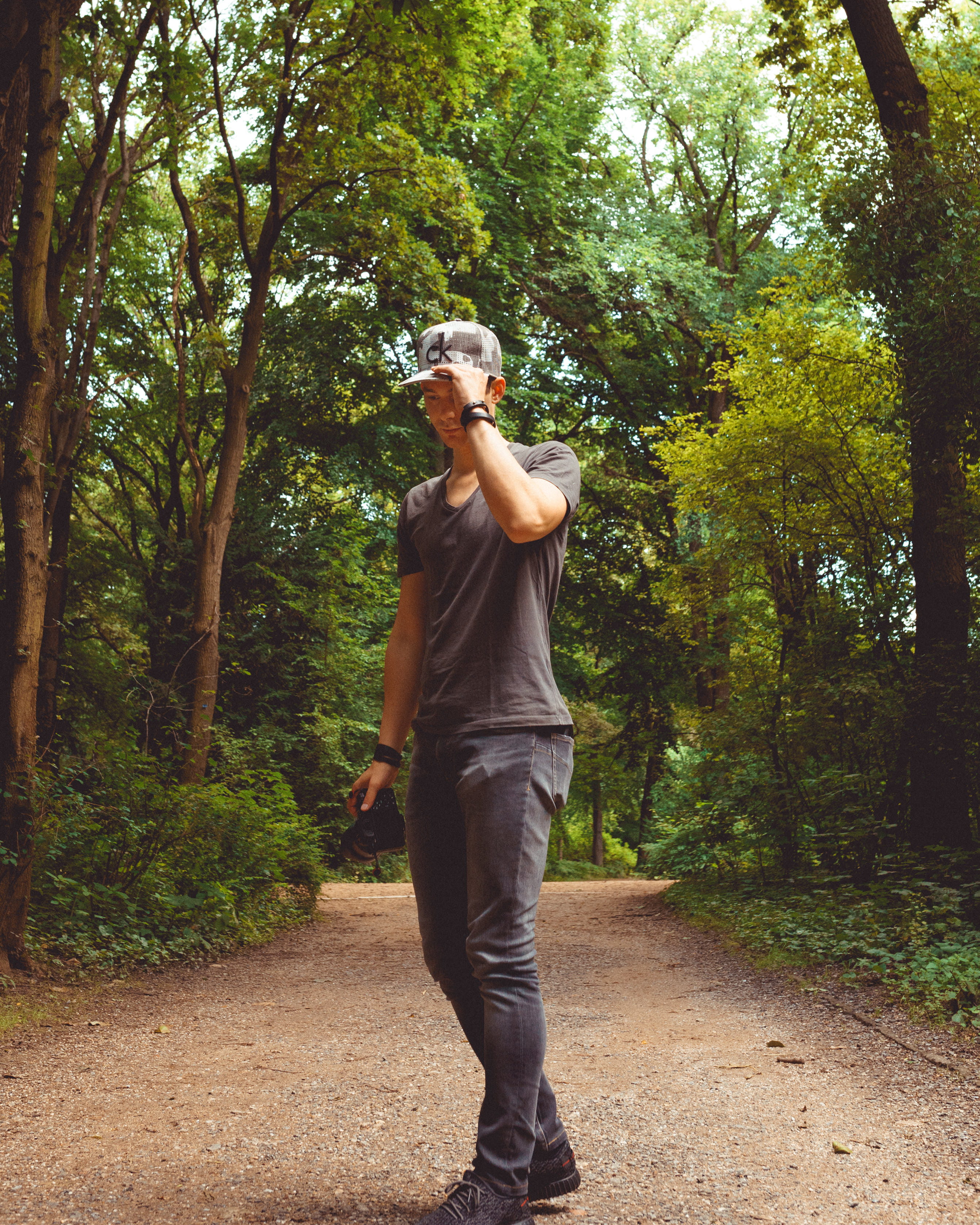 person, growth, leisure activity, forest, germany, wristbands, 2K, day, real people, green, thinking, path, plant, tree, males, t-shirt, base cap, one person, Phone HD Wallpaper