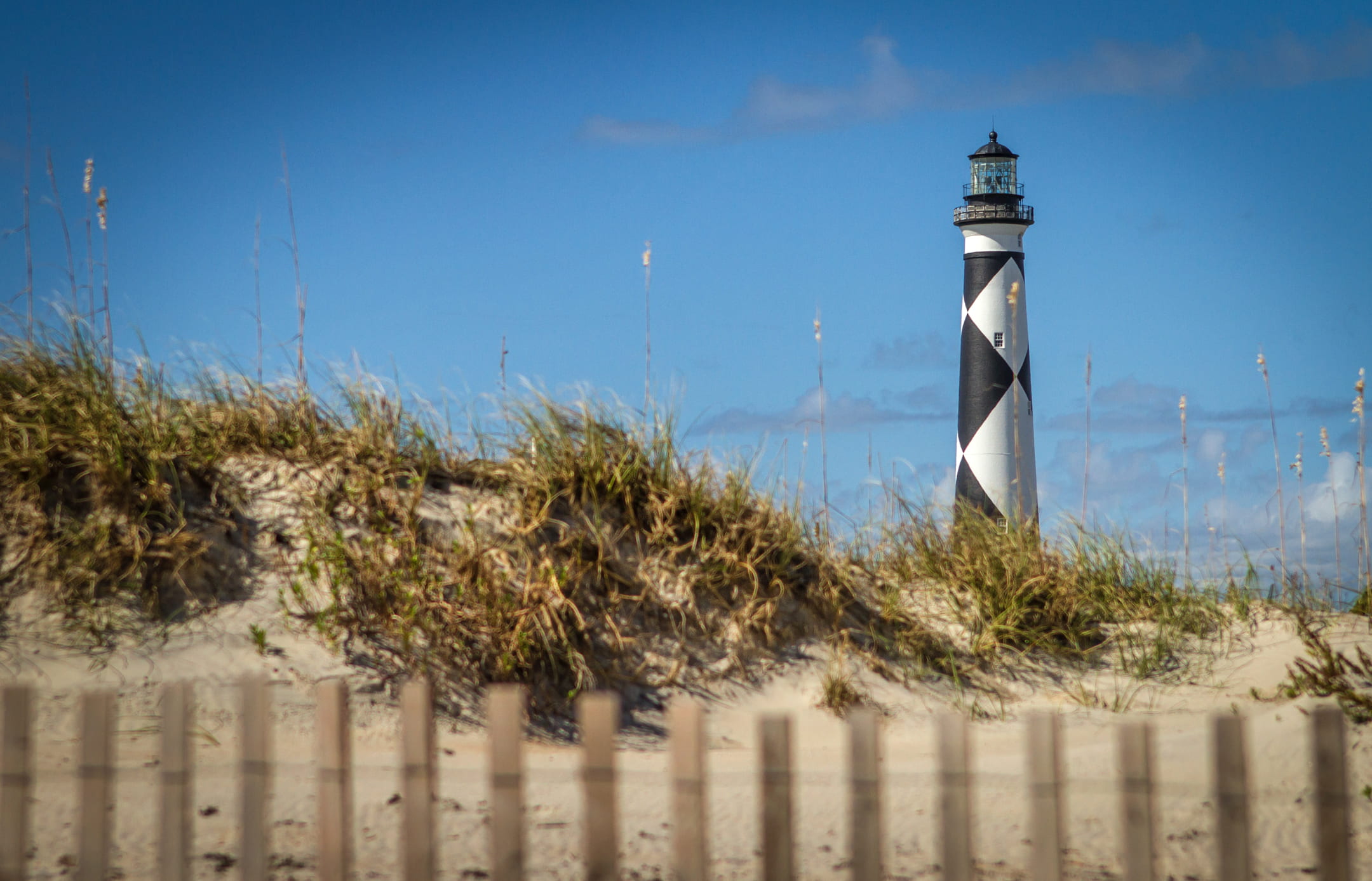 security, no people, sand, grass, mountain, lighthouse, tower, day, blue, nature, safety, dune, sky, black, 1080P, light house, architecture, building exterior, HD Wallpaper