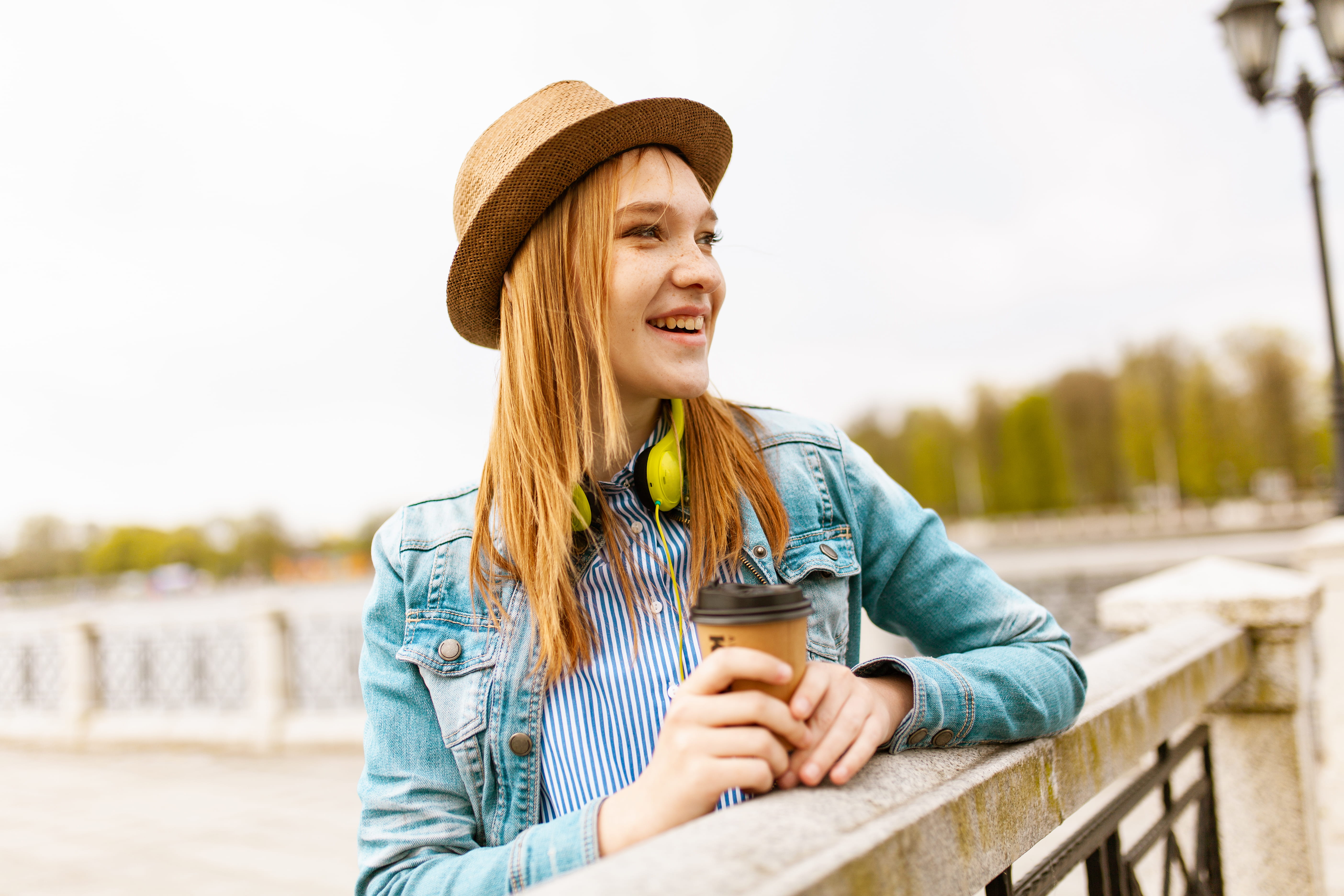 attractive, cup, young women, hair, blurred background, cheerful, emotion, young, toothy smile, daylight, sunny, hat, clothing, nature, earphone, day, hand, HD Wallpaper
