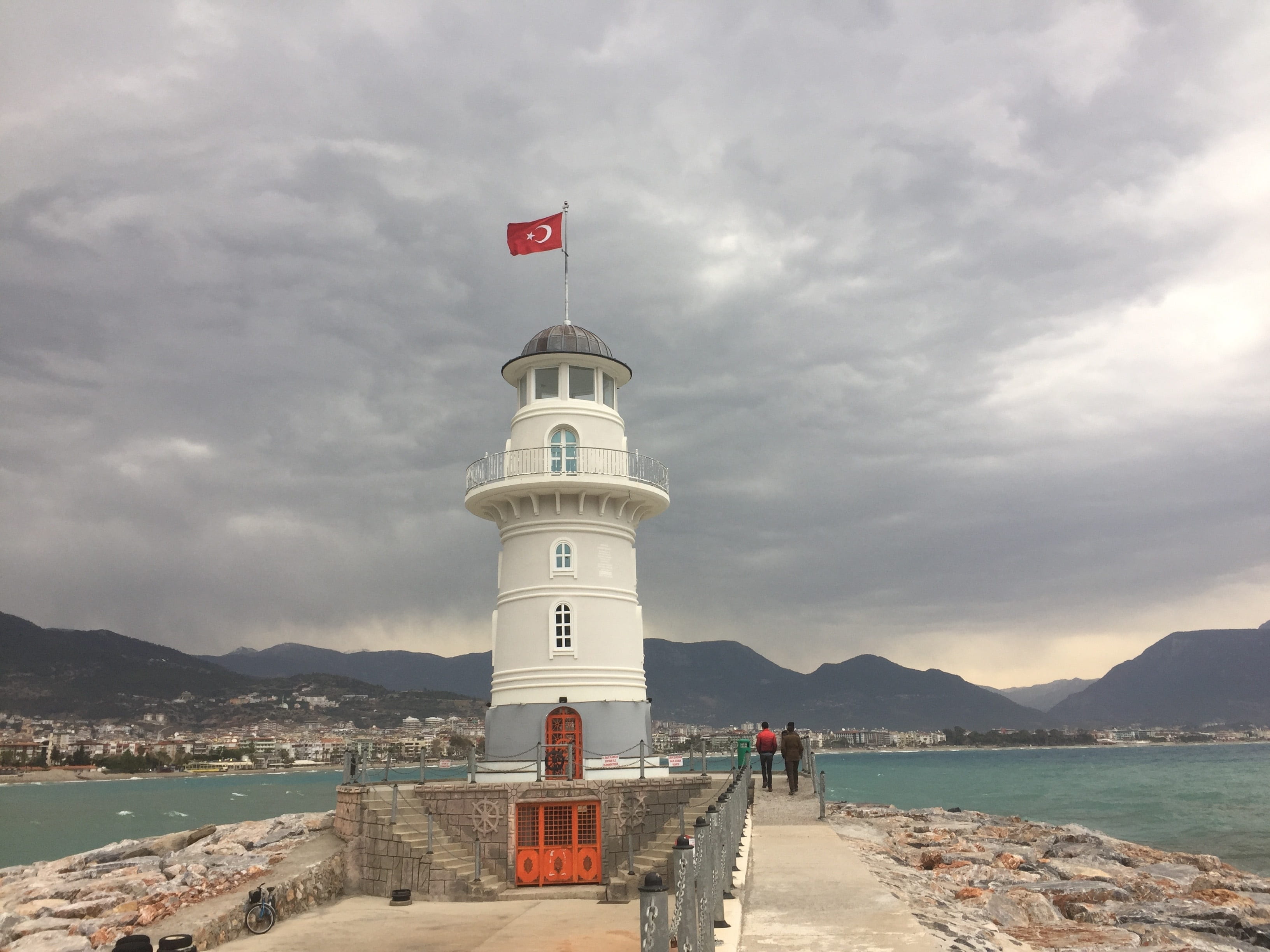 nature, built structure, alanya, mountain range, 2K, sea, cloudy, lighthouse, architecture, clouds, outdoors, building, water, sky, cloud - sky, direction, HD Wallpaper