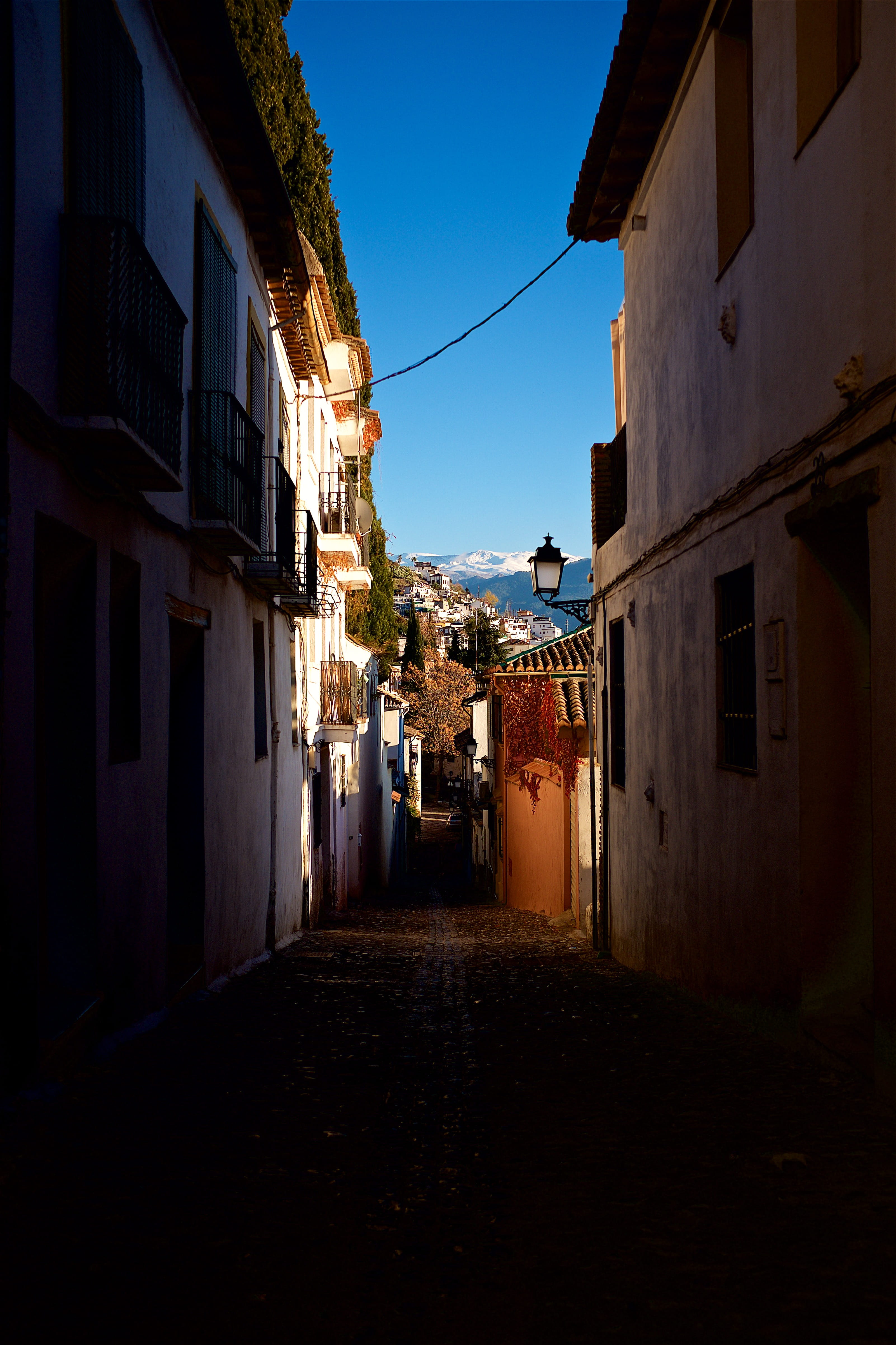 narrow, residential district, diminishing perspective, lantern, alley, shadow, city, the way forward, andalucia, street, wall, nature, building exterior, Phone HD Wallpaper