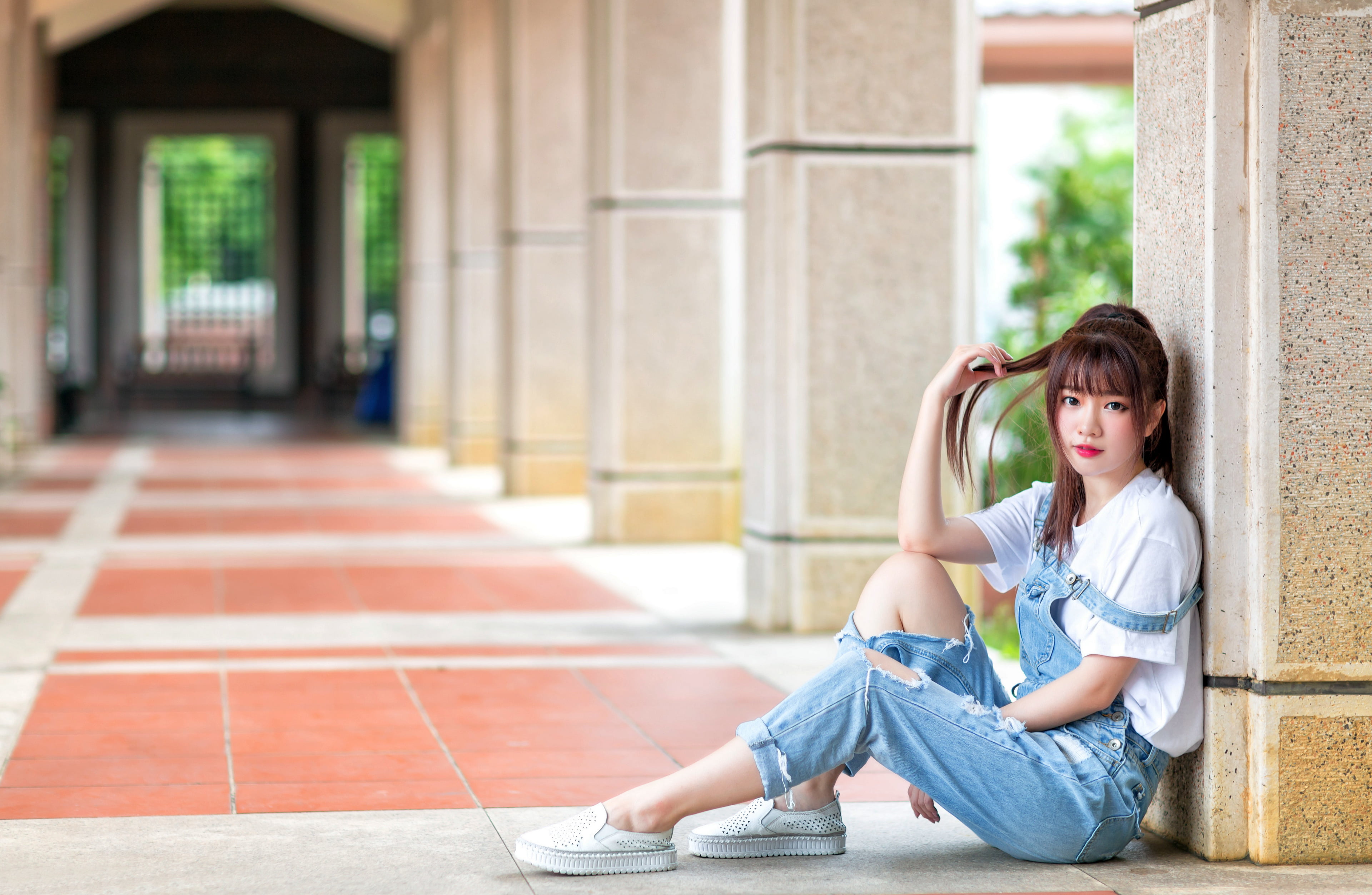jumpsuit, leaning, Bushes, brunette, hallway, jeans, white shirt, column, 4K, sitting, model, white shoes, long hair, Asian, women, HD Wallpaper