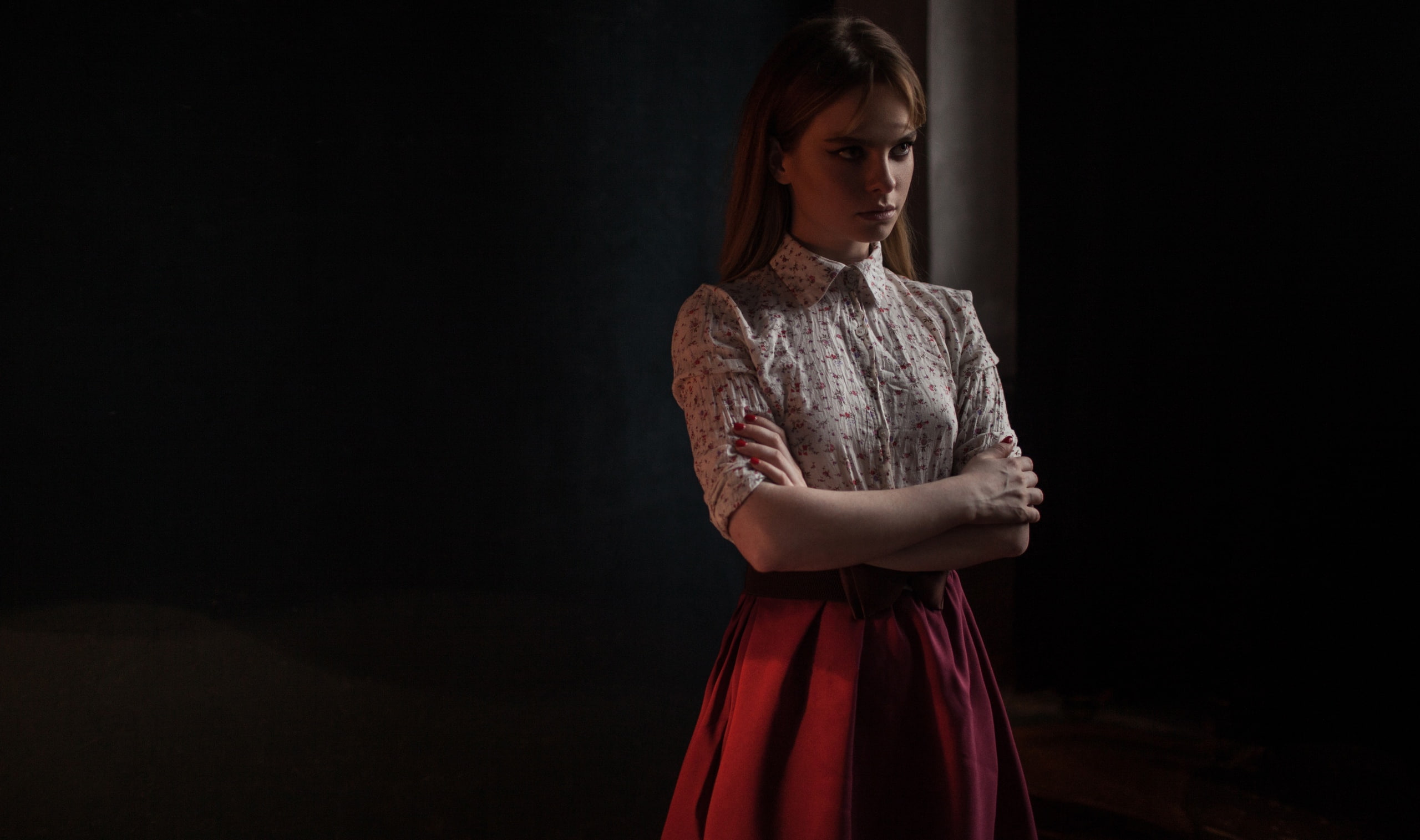 red skirt, portrait, 2K, dark, arms crossed, standing, women indoors, skirt, looking away, indoors, model, women, shirt, brunette, red nails, HD Wallpaper
