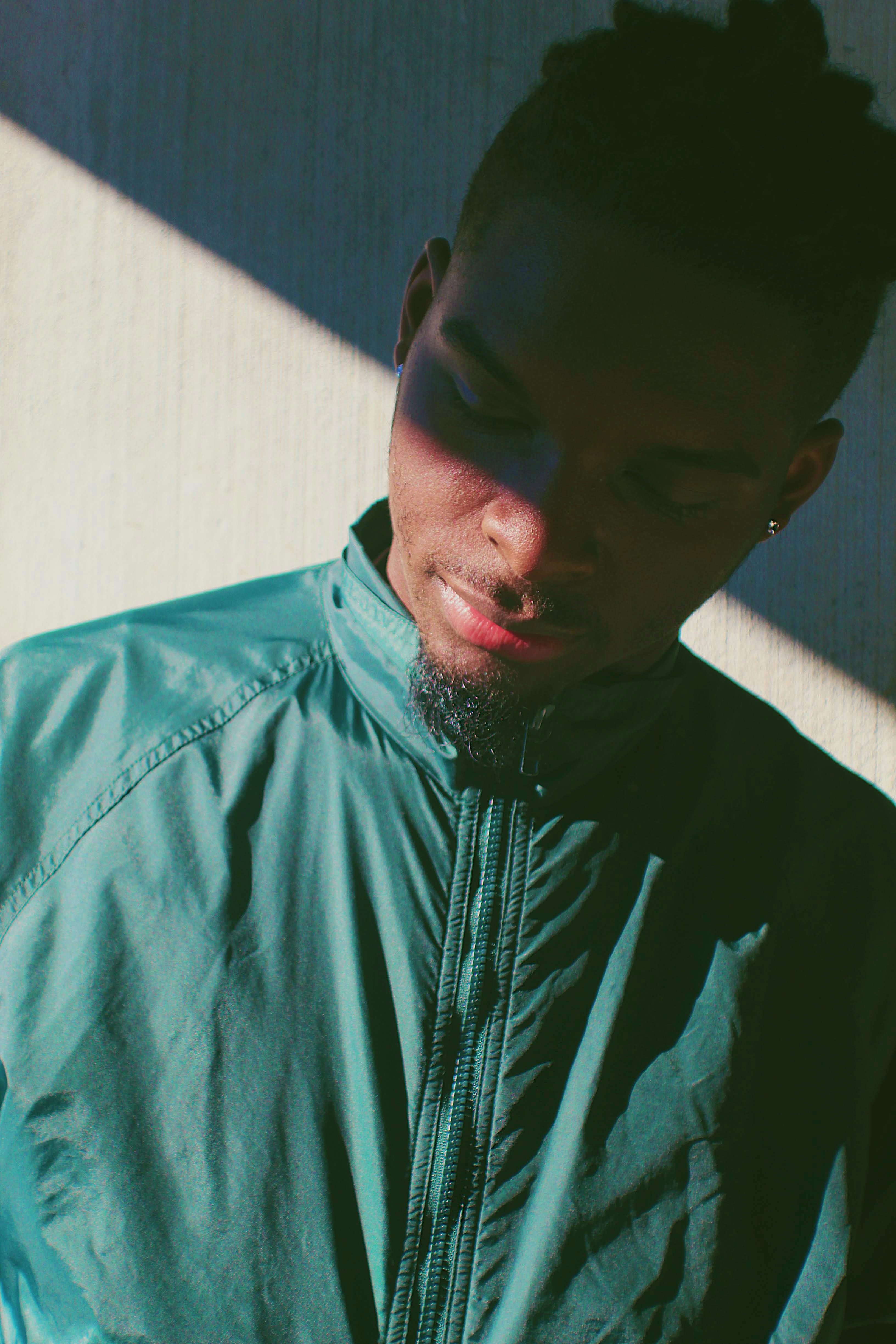 waist up, sunlight, standing, contemplation, clothing, men, windbreaker, young adult, leisure activity, portrait, green, lifestyles, one person, warm clothing, Phone HD Wallpaper