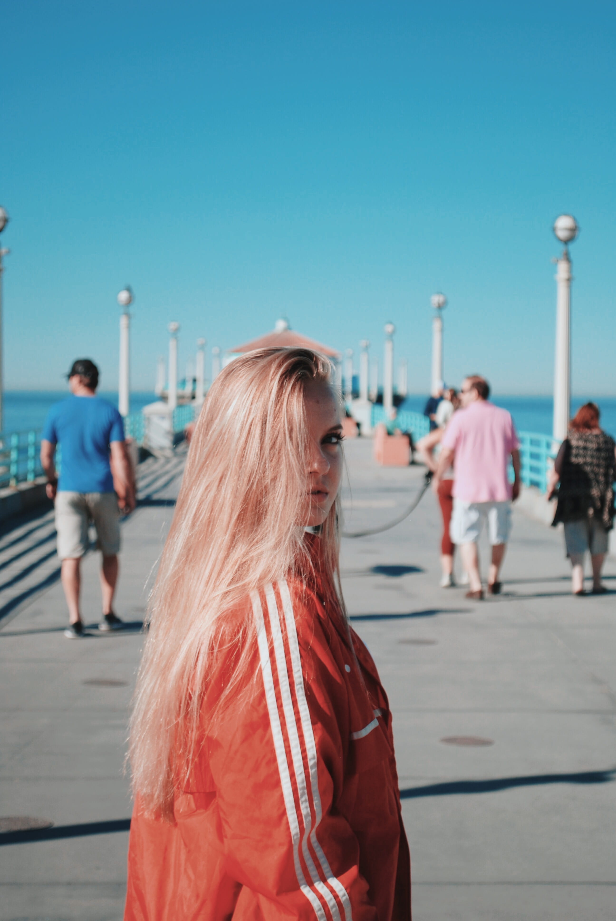 tourist, windbreaker, leisure activities, wearing, leisure activity, day, pink, building, running track, dock, focus on foreground, walking, pedestrian, Phone HD Wallpaper