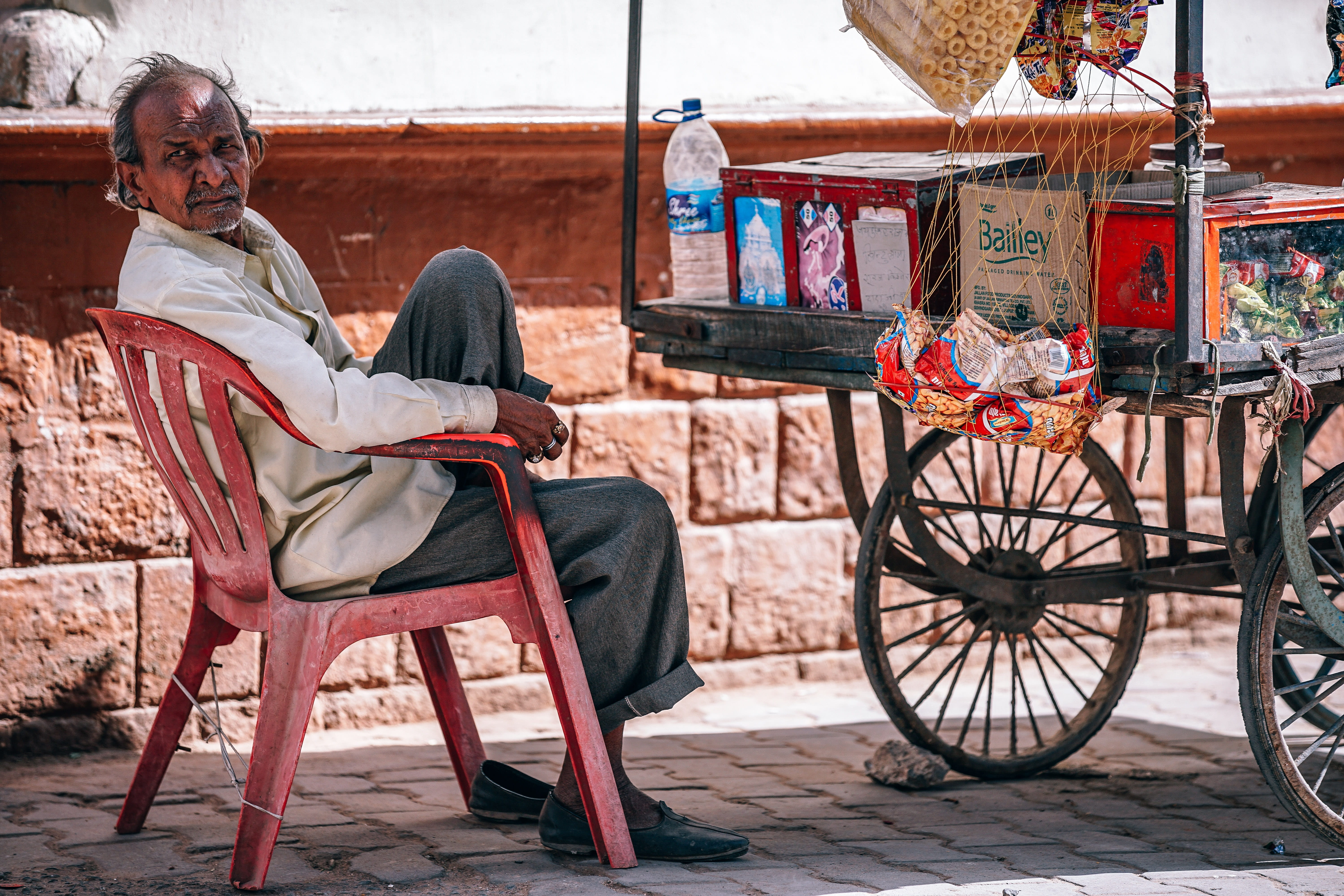 india, casual clothing, waiting, beside, snacks, relaxation, outdoor, asian, cart, one person, sweet, dress, street, full length, sitting, colorful, males, HD Wallpaper