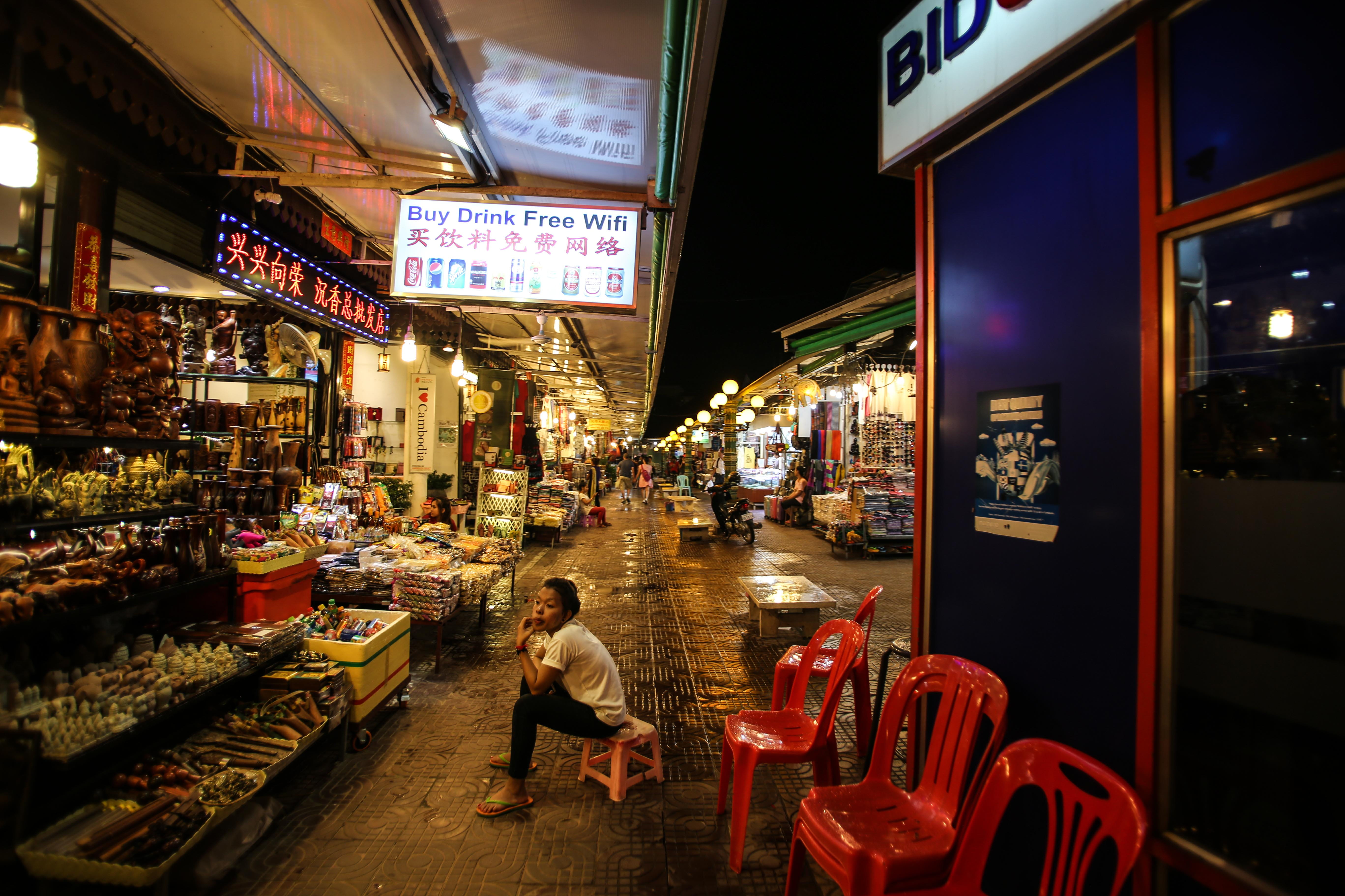 siem reap, store, men, illuminated, women, city life, night, market, choice, krong siem reap, 5K, built structure, real people, text, cambodia, one person, HD Wallpaper
