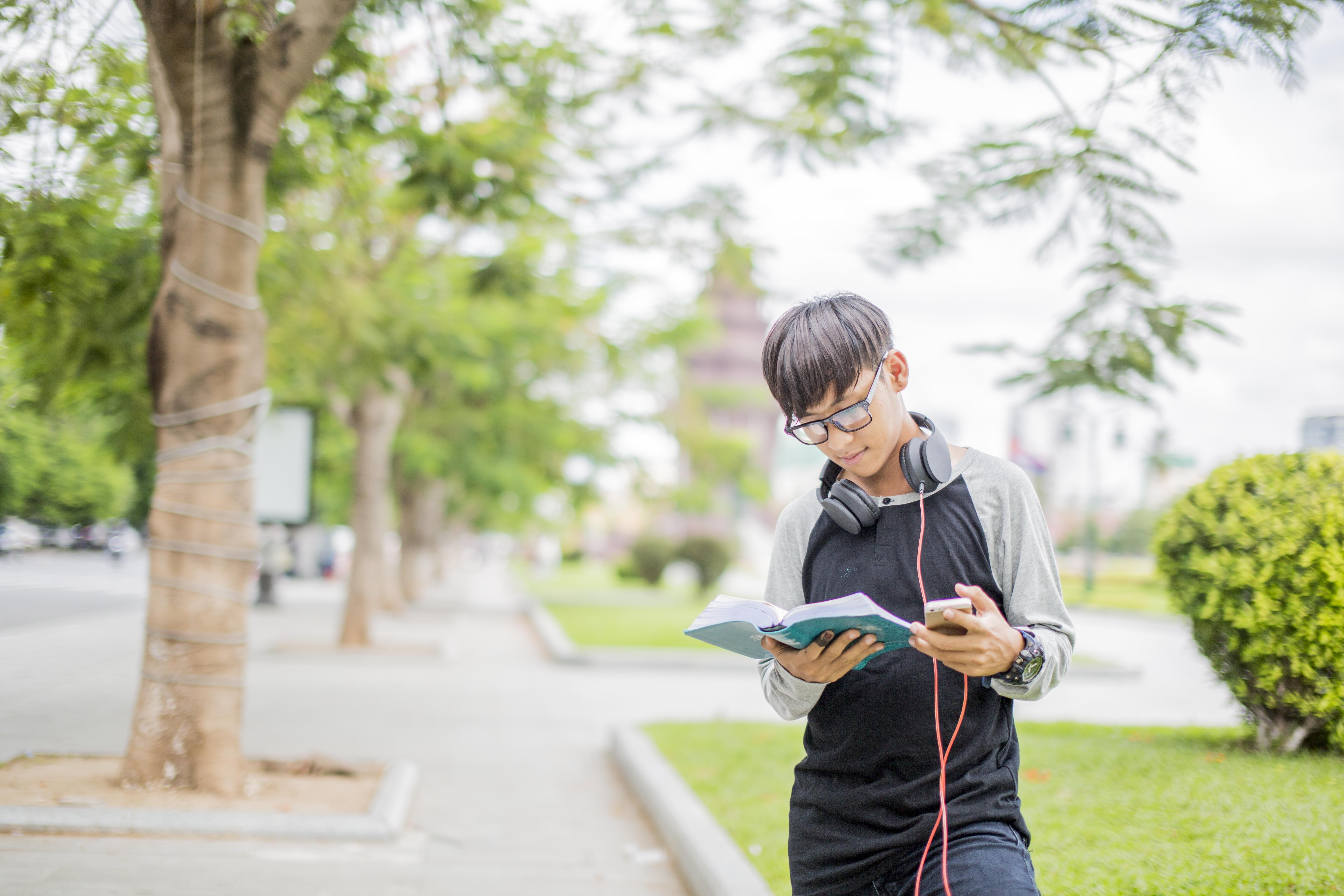 tree, youth, one person, path, plant, looking, technology, look, communication, wearing, person, outdoors, headset, khmer, holding, man, 5K, reading, publication, HD Wallpaper