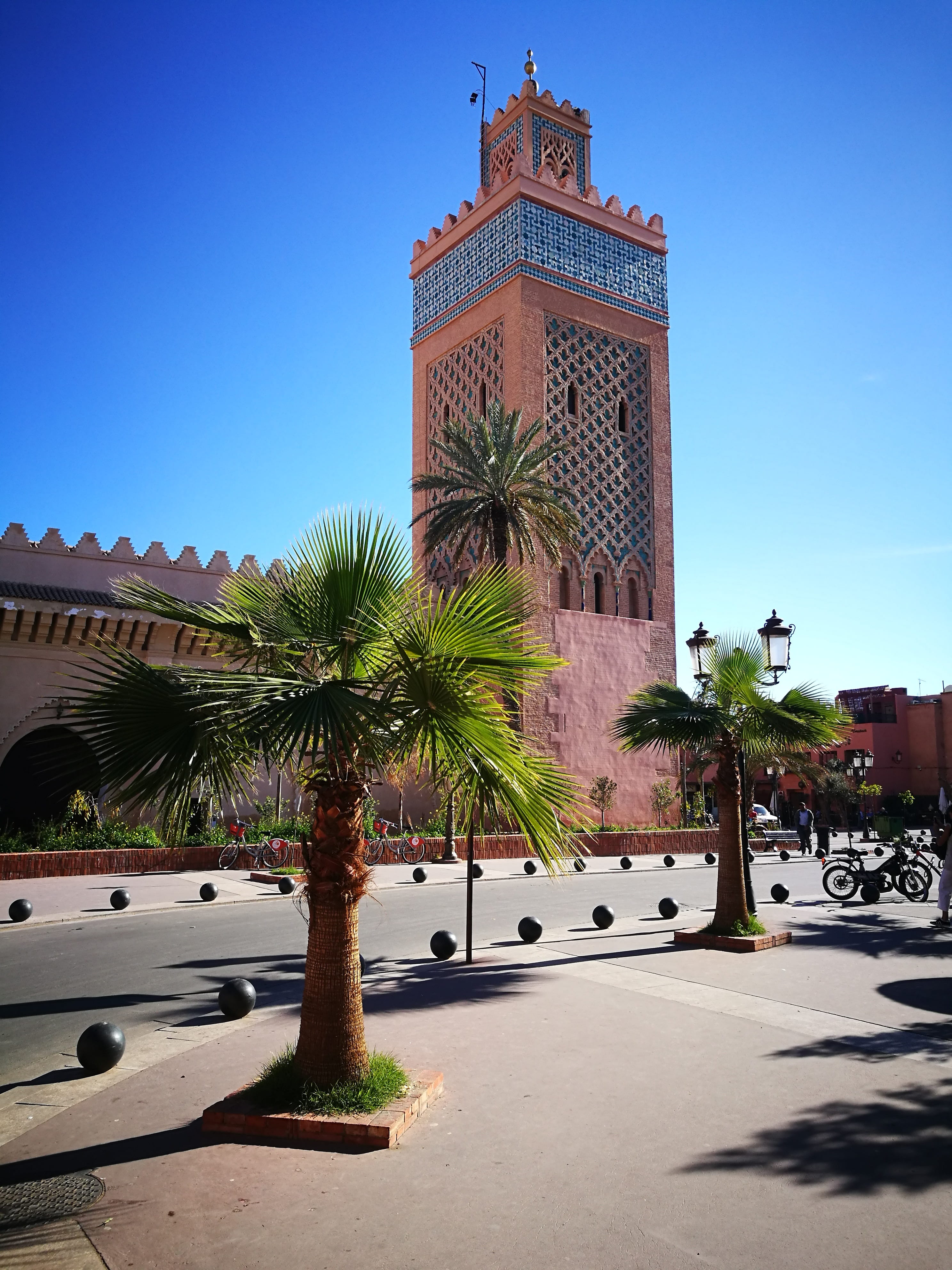 historian, travel, marrakesh, city, building exterior, palm tree, tower, sky, outdoors, big city, tree, nature, construction, mode of transportation, tourism, Phone HD Wallpaper