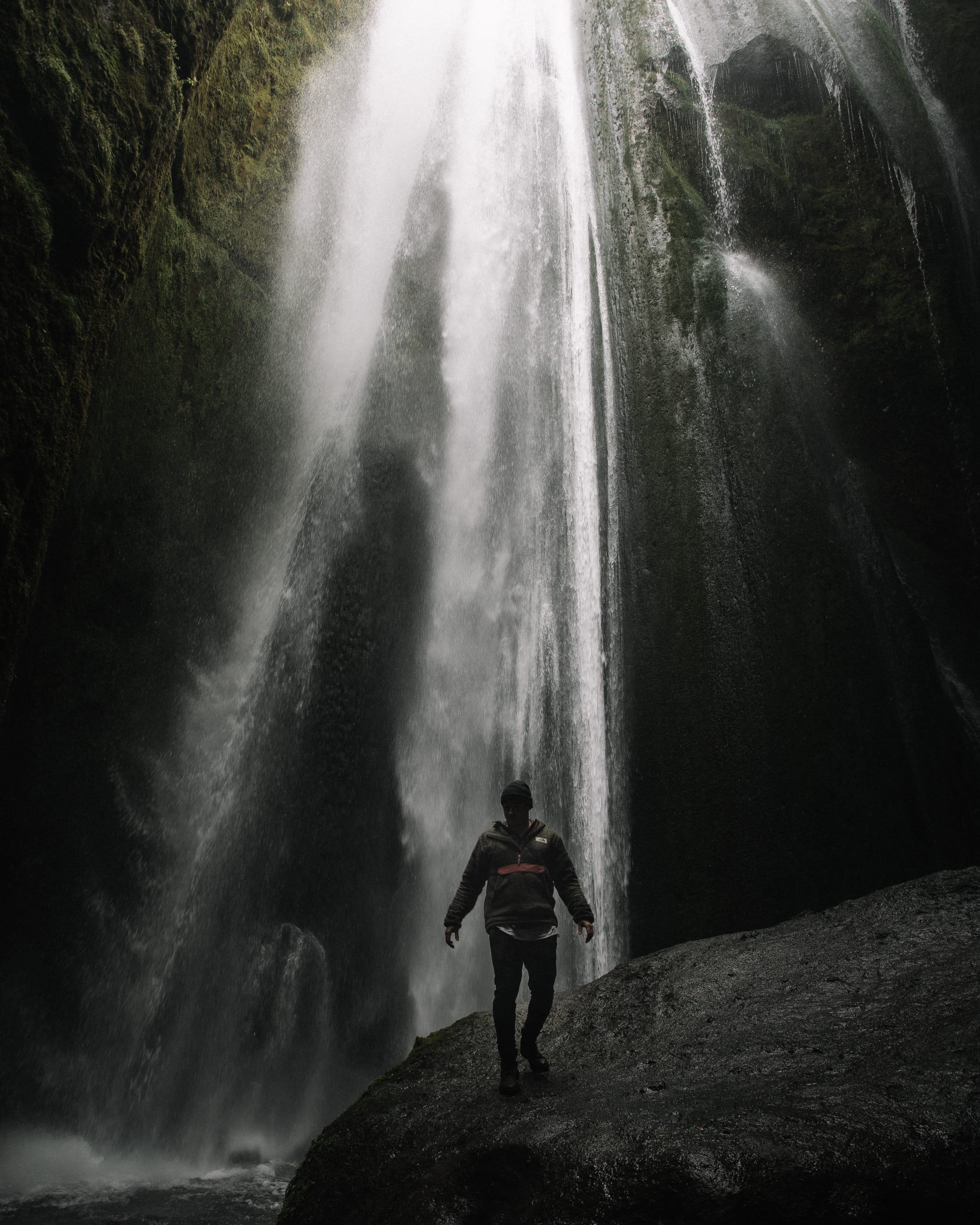 women, standing, hat, dark, waterfalls, mountain, falling, wet, adult, jacket, waterfall, river, near, beautiful destination, 4K, rock, beauty In Nature, Phone HD Wallpaper
