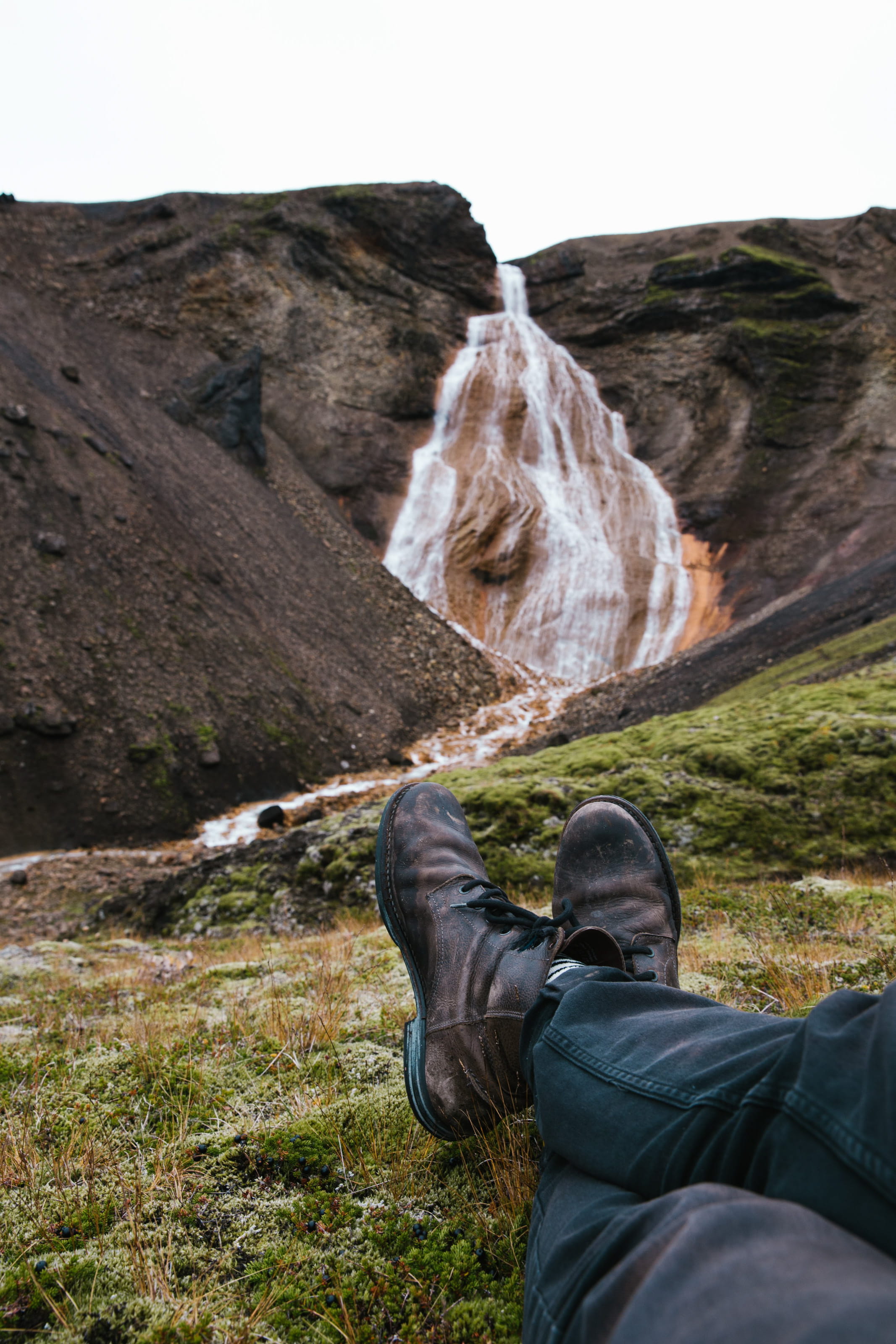 scenics - nature, day, stone, one person, man, moss, human leg, 2K, water, calm, shoes, casual clothing, human body part, travel, nature, outdoor, Waterfall, Phone HD Wallpaper