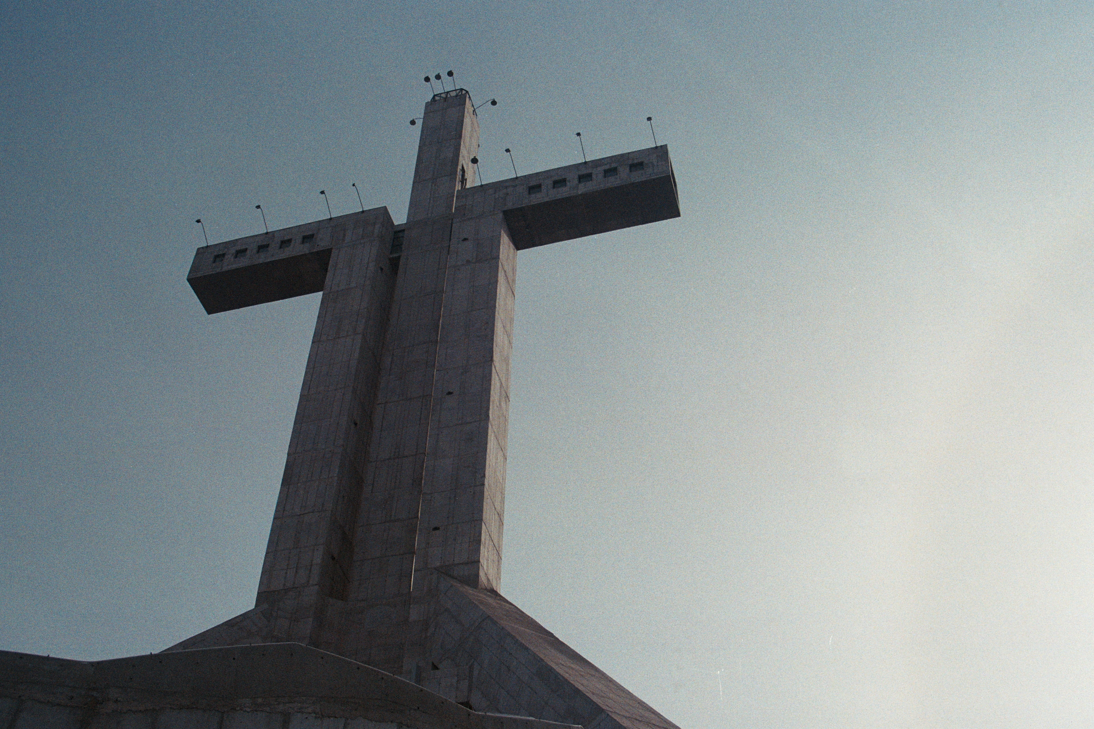 the past, clear sky, spirituality, built structure, concrete, religious equipment, religion, cross, outdoors, sky, architecture, tower, tall - high, low angle view, HD Wallpaper