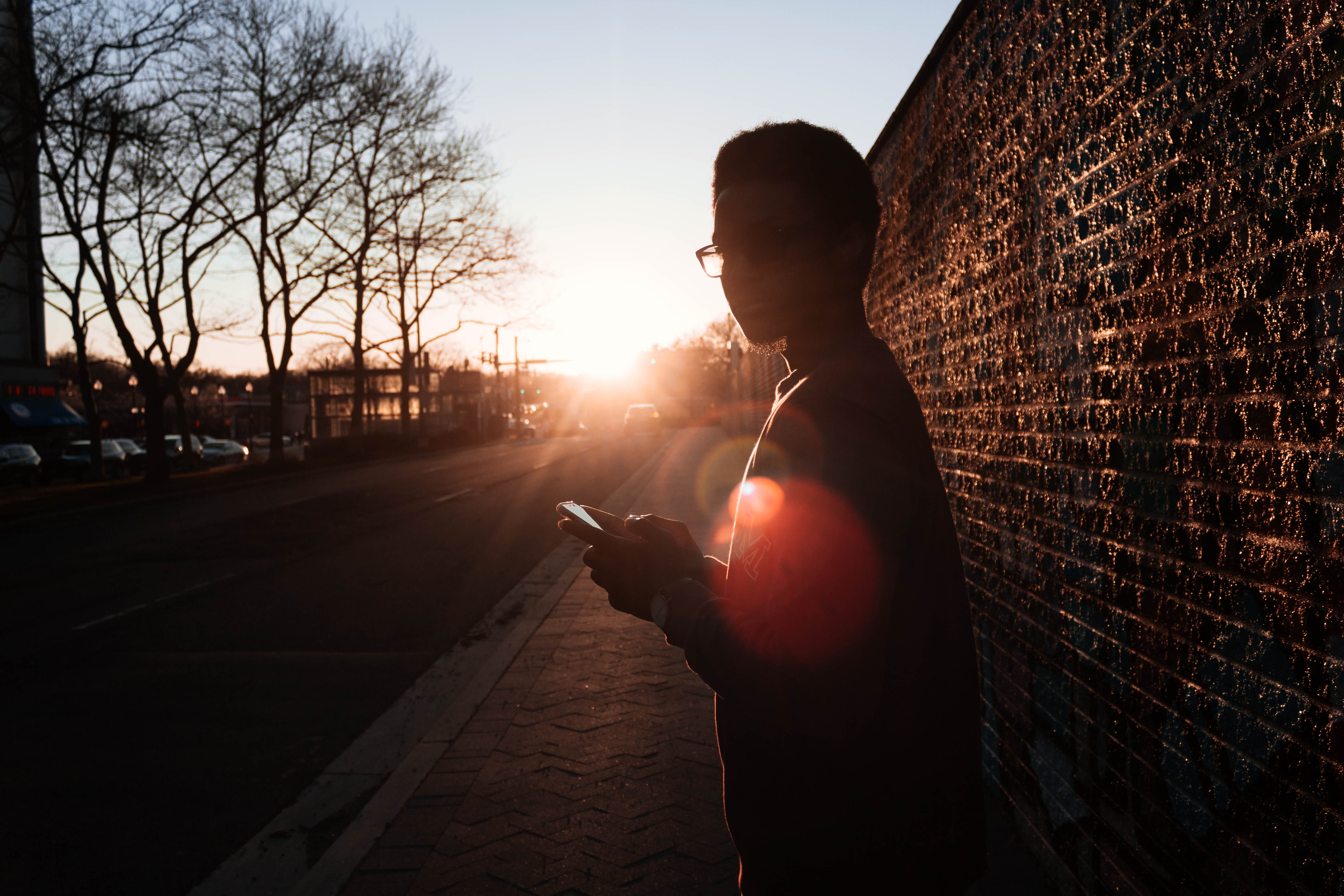 trees, smart phone, scenic, leisure activity, sunset, transportation, sunrays, eyewear, holding, wall, sideways, sunlight, environment, person, fashion, HD Wallpaper