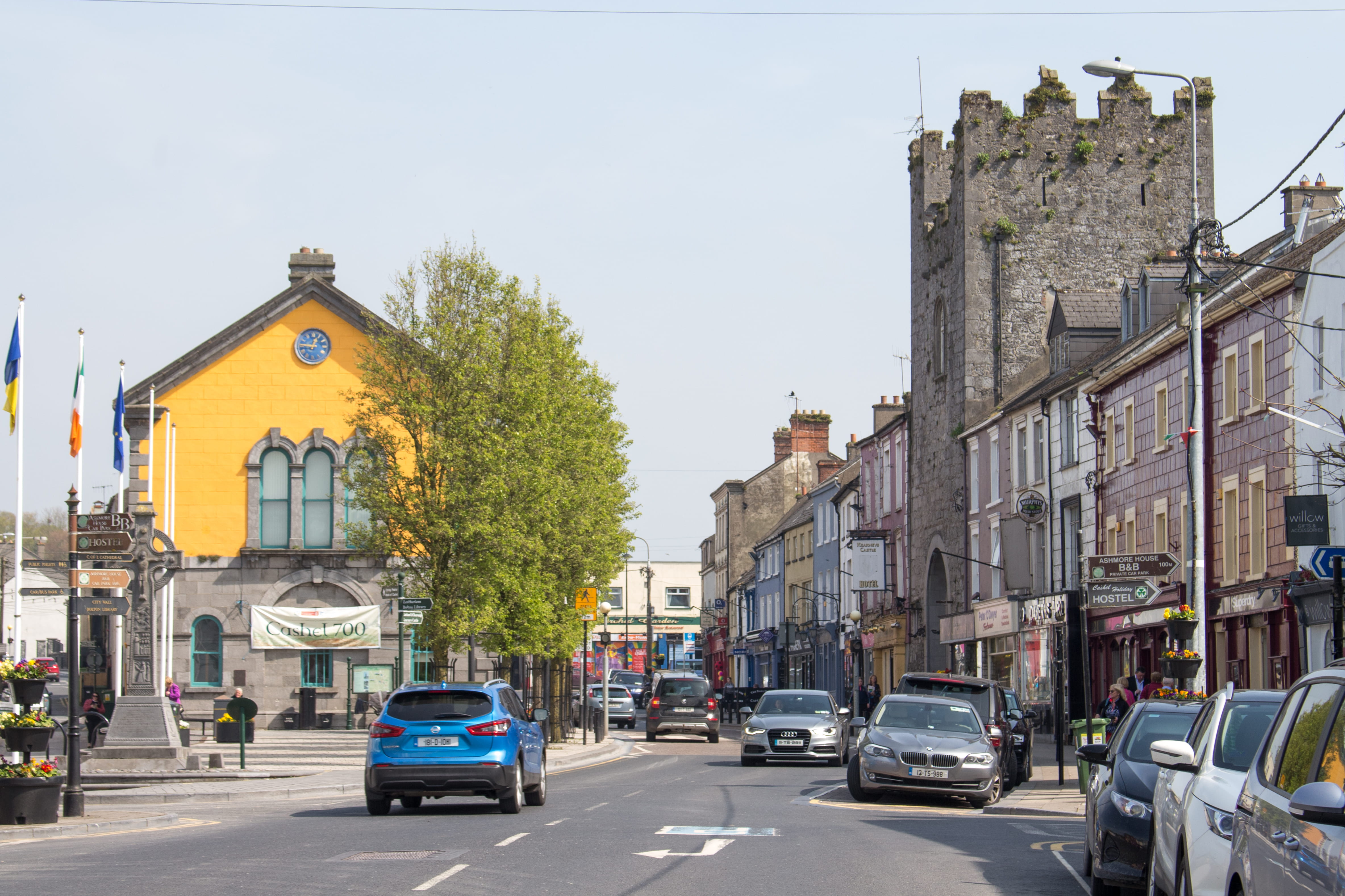 sign, road, mode of transportation, car, cashel, building exterior, town, buildings, license plate, asphalt, street, land vehicle, city street, sports car, HD Wallpaper