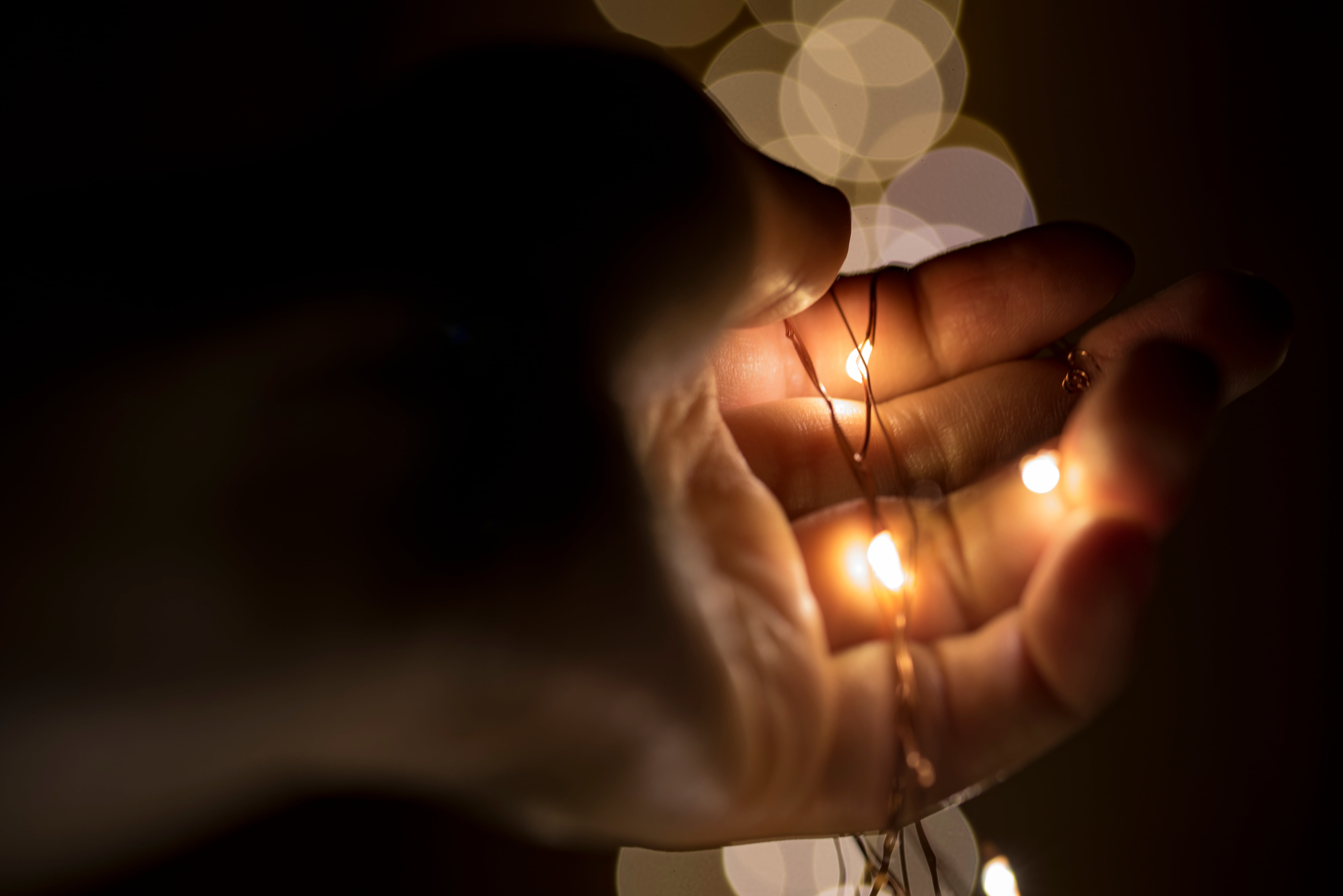 close-up, adult, hand, light, holding, women, fire, season, illuminated, 5K, lights, bokeh, finger, christmas, holiday, string, flame, adults only, human hand, HD Wallpaper
