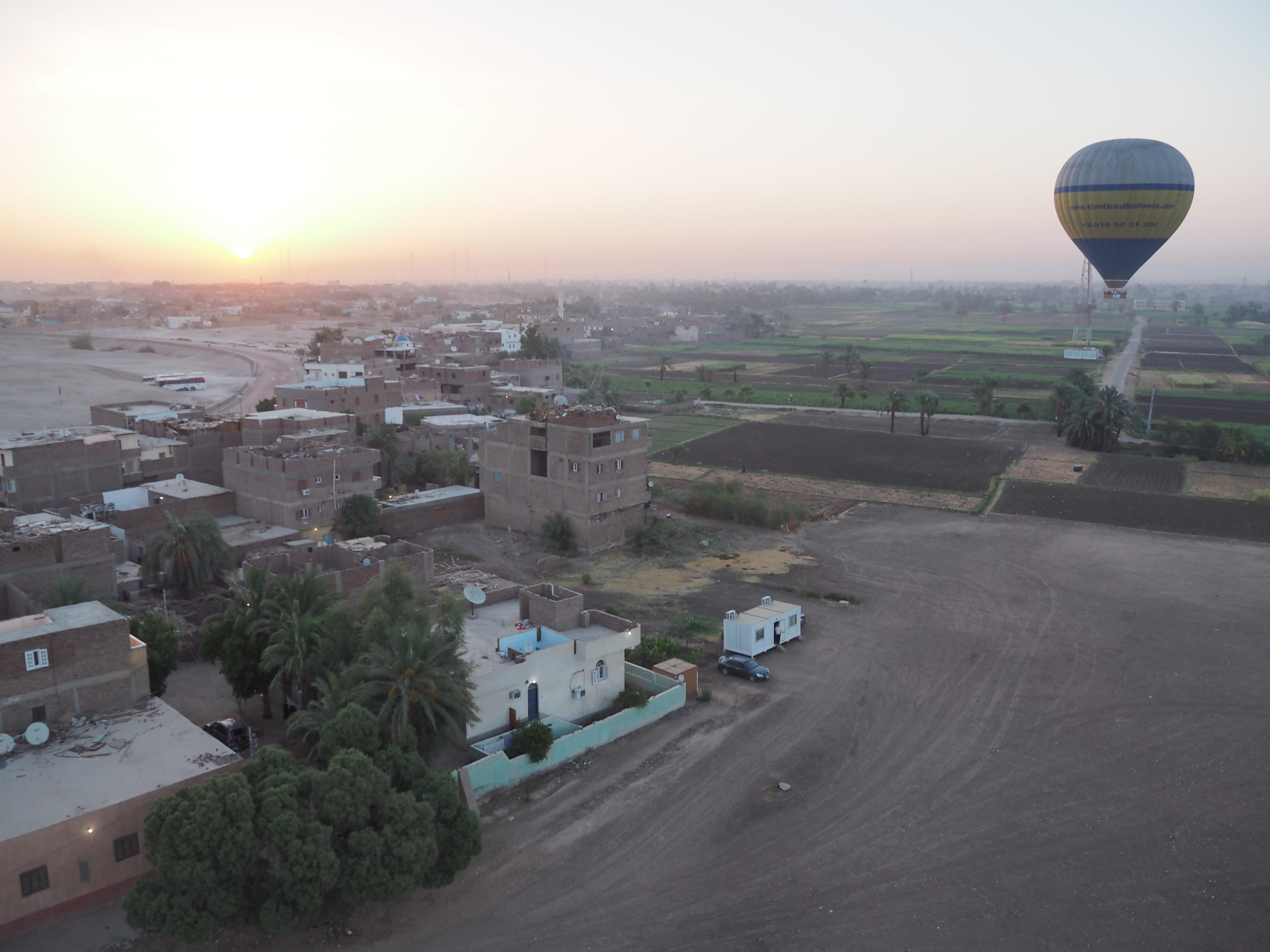 aswan, no people, hot air balloon, air vehicle, desert, building exterior, plant, egypt, sunset, city, mode of transportation, flying, sky, road, high angle view, HD Wallpaper
