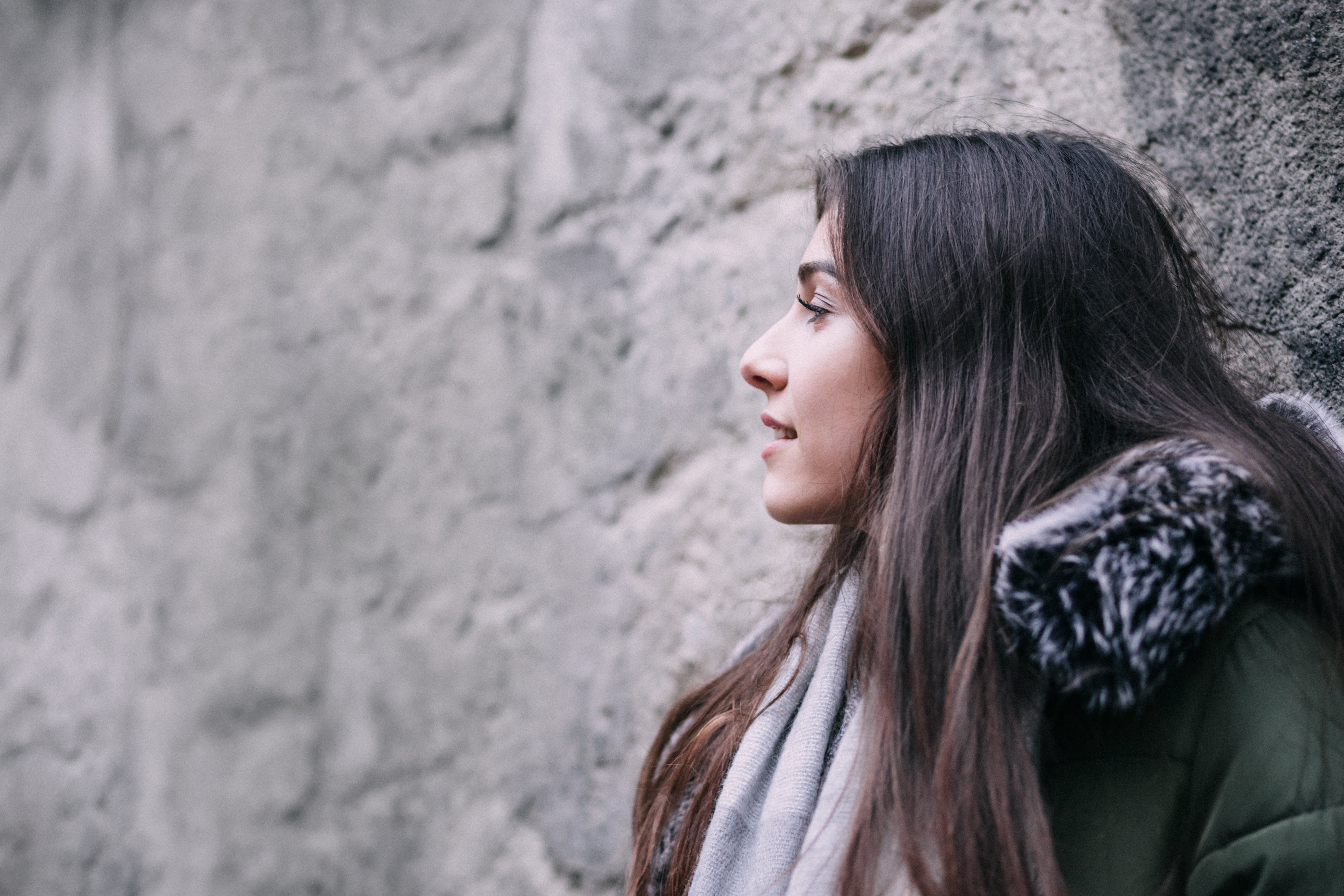 hair, females, looking, nature, looking away, woman, smiling, young Adult, people, coat, warm clothing, outdoors, brown hair, gray, concrete, green, contemplation, HD Wallpaper