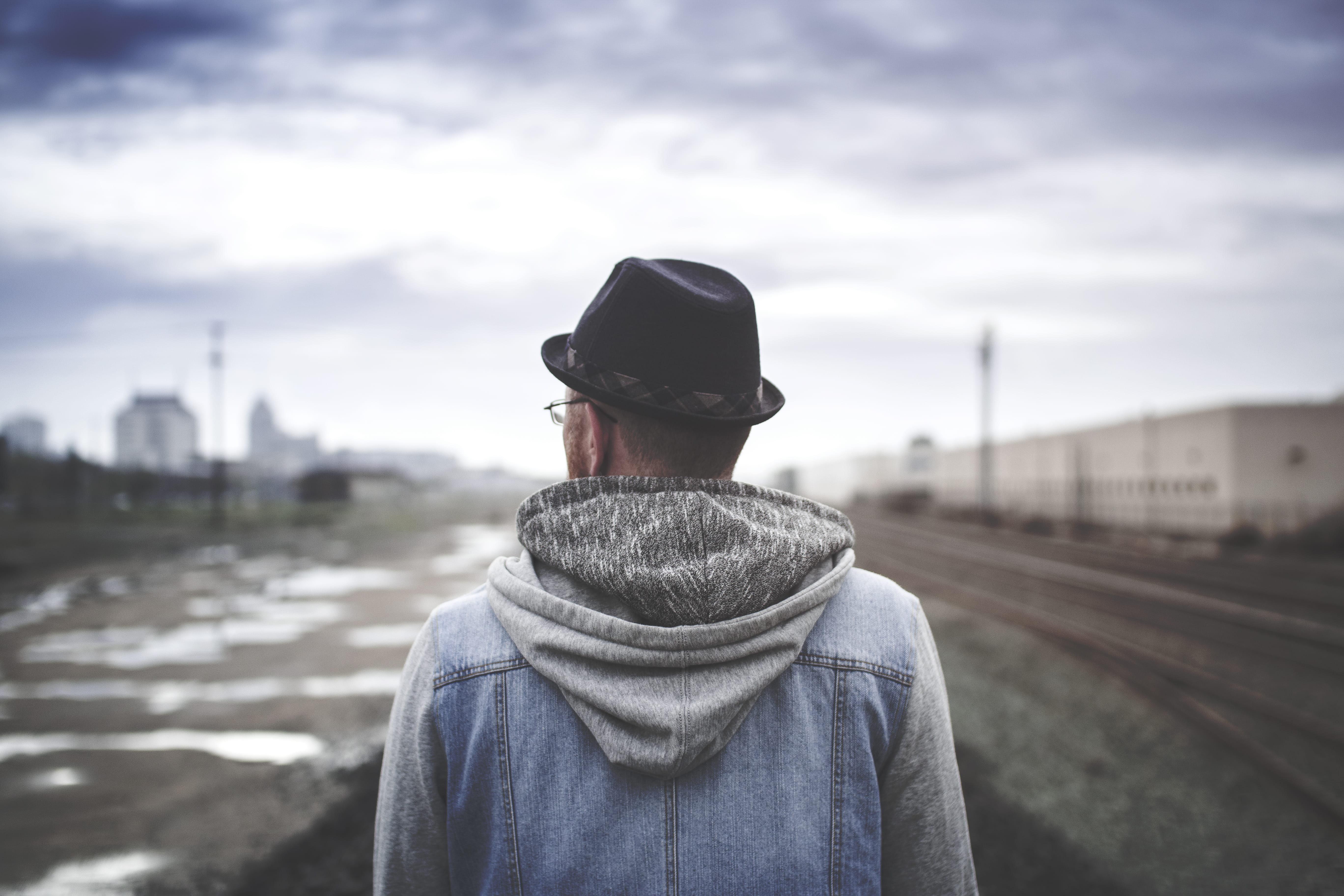 hood - clothing, overcast, 5K, architecture, depressed, depression, red hair, outdoors, transportation, nature, railroad track, thinking, vibes, standing, HD Wallpaper