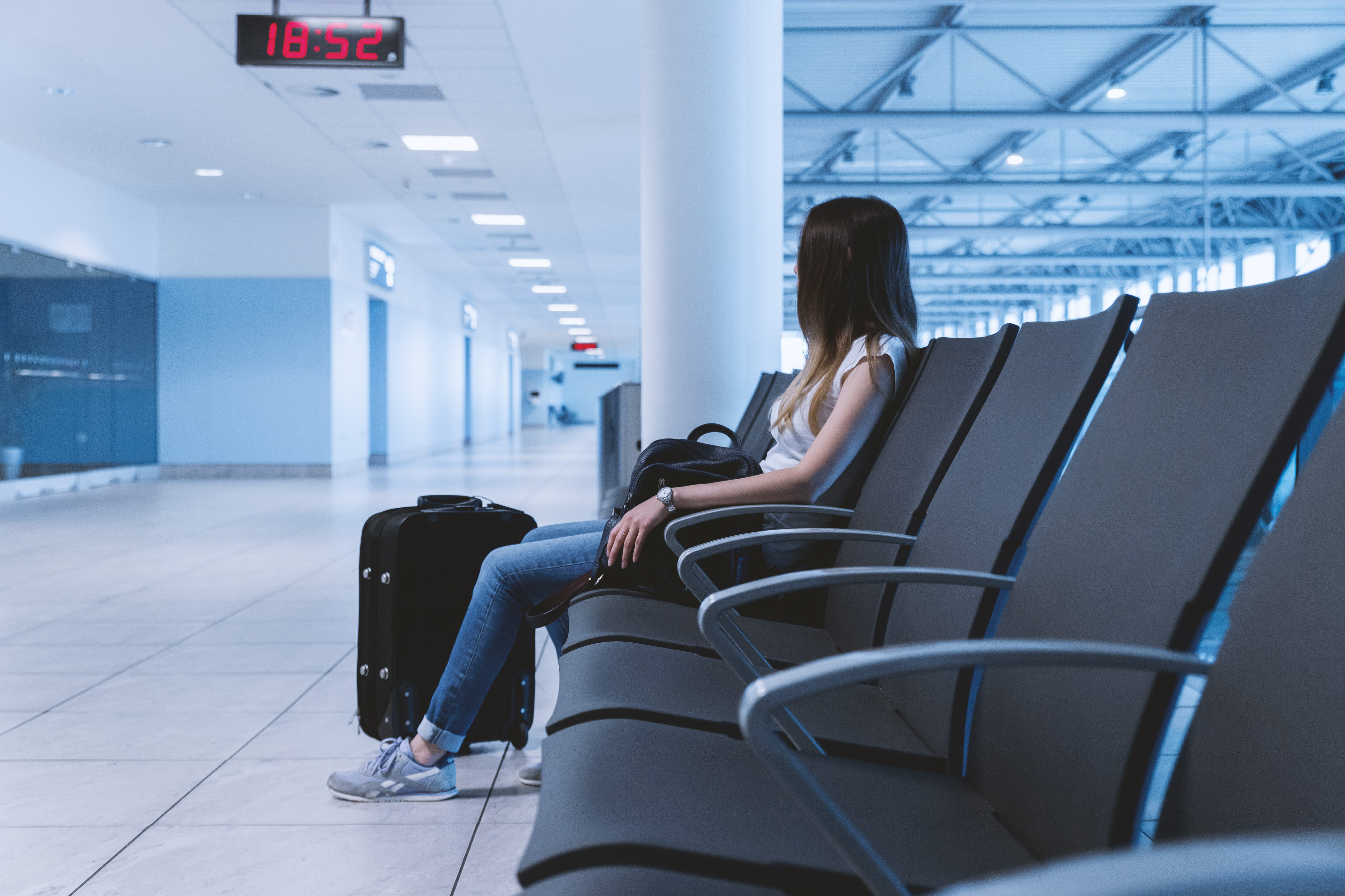 sitting, seat, hair, young adult, indoors, airport departure area, one person, women, travel, casual clothing, ceiling, adult, real people, airport, waiting, HD Wallpaper