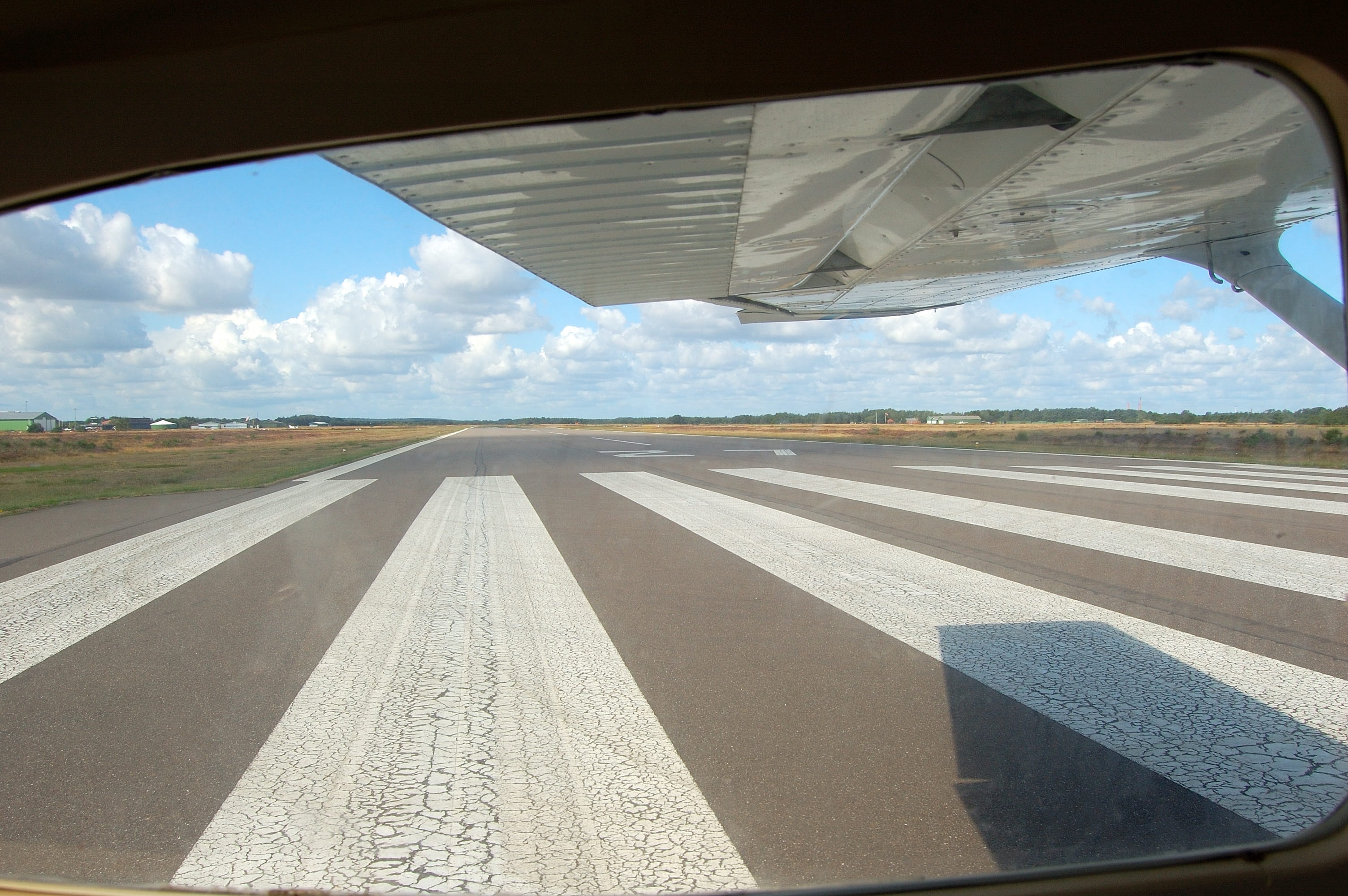 aircraft, flight, concrete, sunlight, symbol, mode of transportation, travel, asphalt, airplane, marking, aviation, cloud - sky, airport, air vehicle, sky, HD Wallpaper