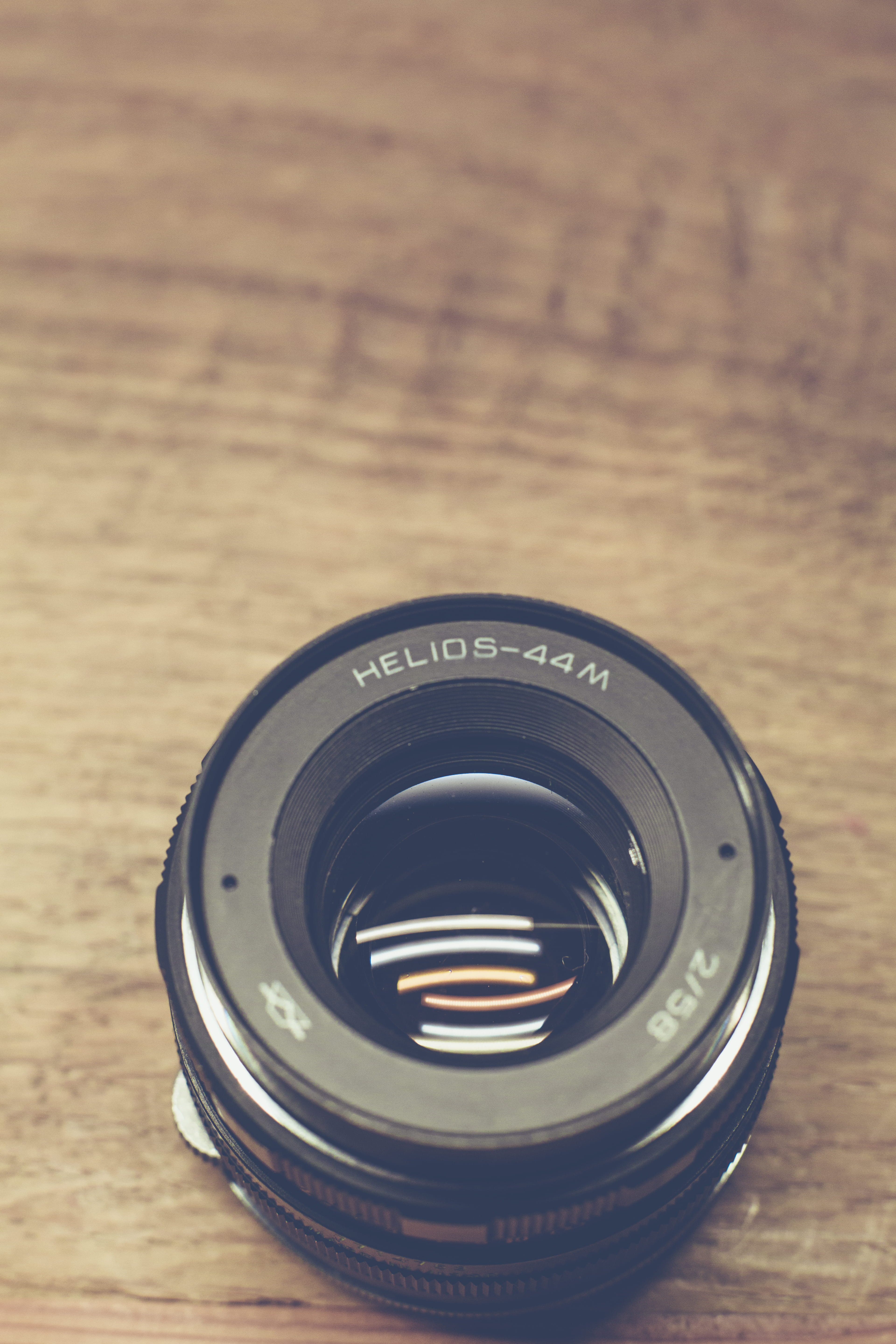 depth of field, photography equipment, close-up, technology, table, wood - material, black color, lens - optical instrument, 5K, high angle view, still life, Phone HD Wallpaper