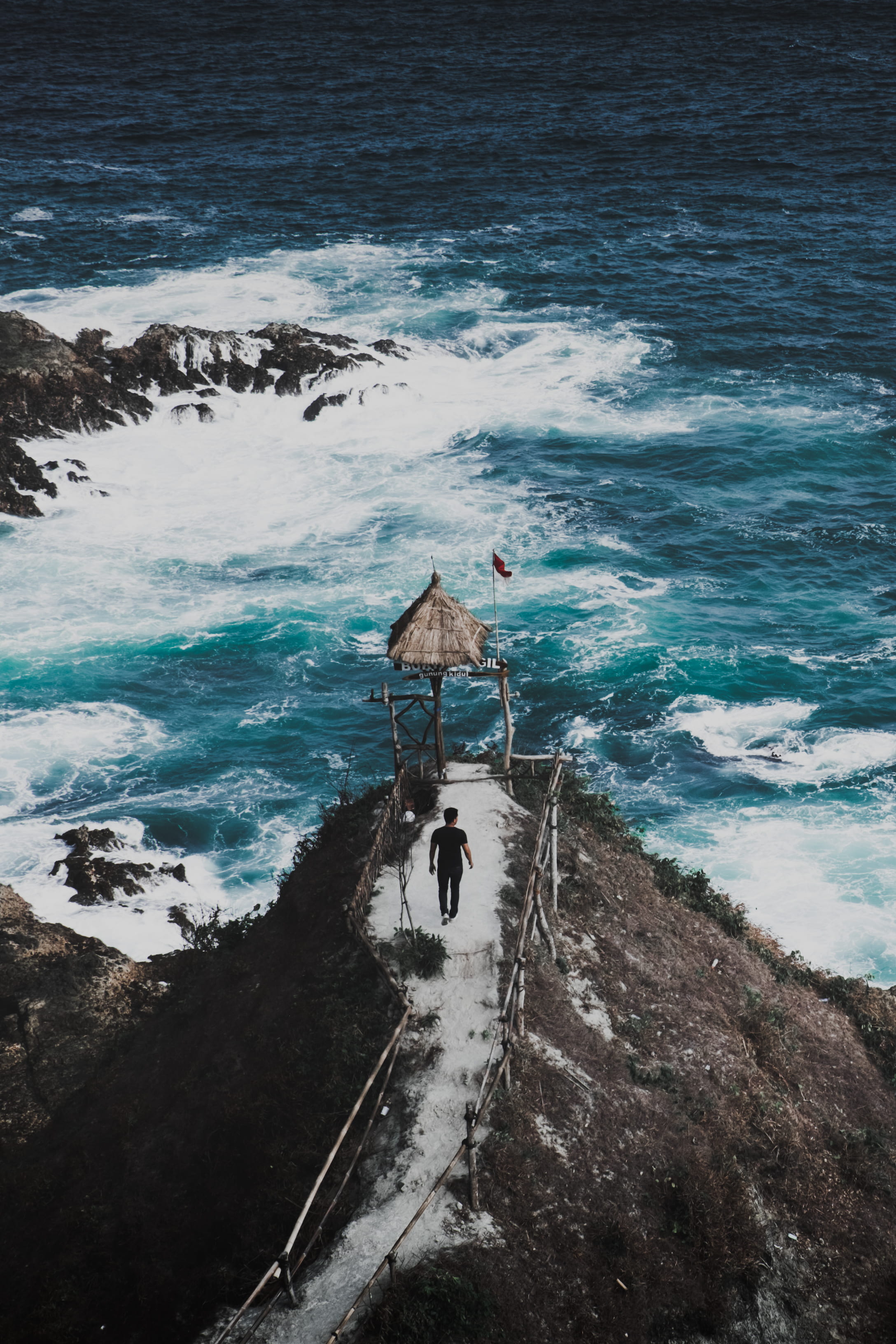 wave, man, real people, lifestyles, male, shack, rock, walking, nature, scenics - nature, surf, towards, sea, day, flag, leisure activity, one person, indonesium, Phone HD Wallpaper