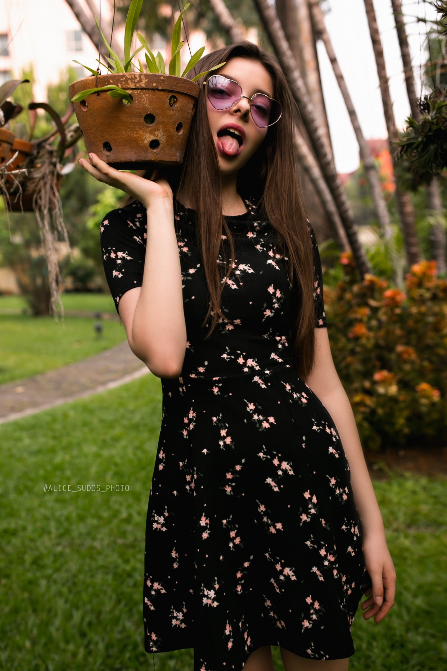 long hair, adult, Alice Sudos Photo, portrait, focus on foreground, young women, tongues, tongue out, plants, flowers, model, outdoors, women outdoors, Phone HD Wallpaper