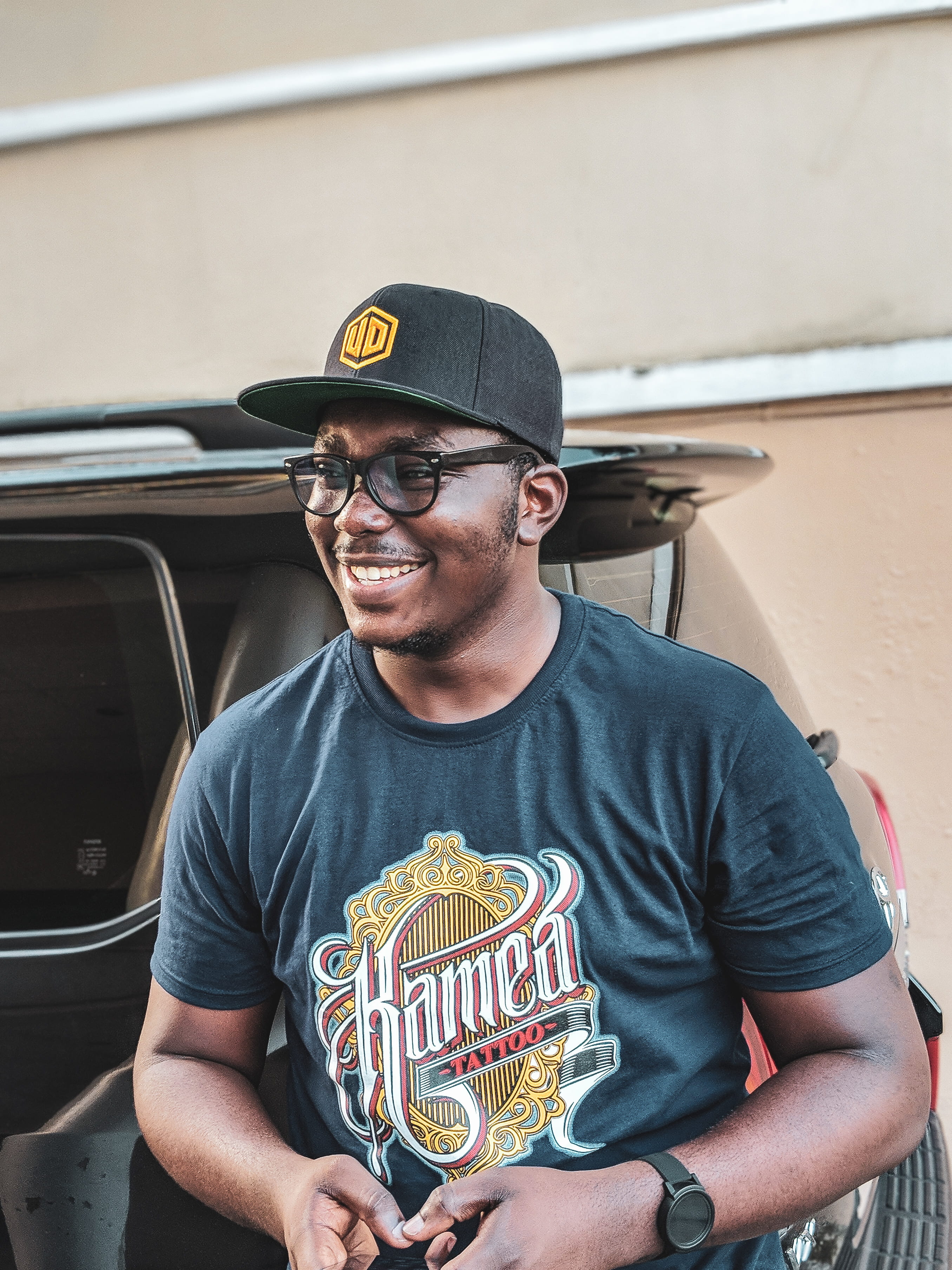glasses, young men, men, watch, emotion, wearing, car, looking at camera, front view, male, smiling, hat, neck, african, youruba, nigerian, day, crew, smile, Phone HD Wallpaper