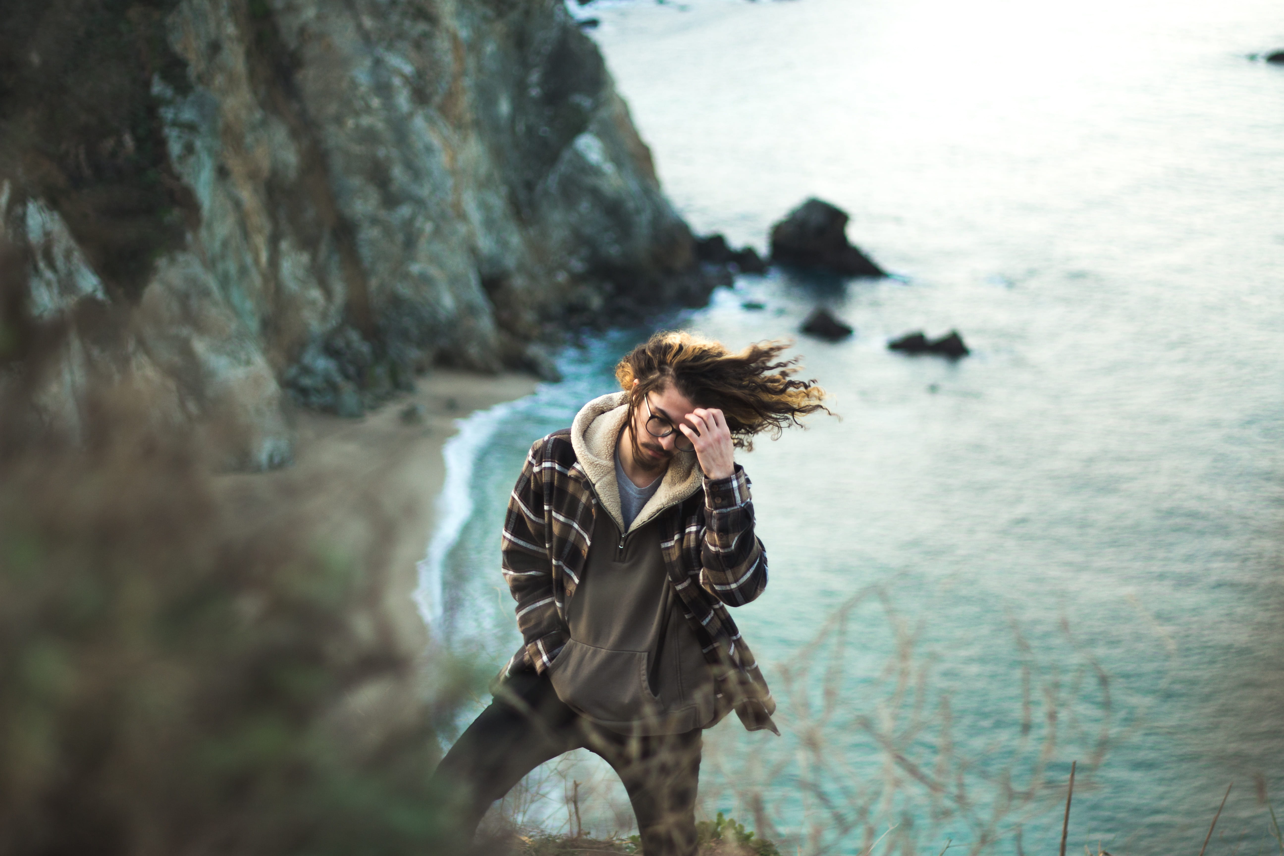 rock, outdoors, young adult, hairstyle, holding, looking, hair, man, adult, 5K, leisure activity, forehead, rock - object, mountain, ocean, standing, nature, HD Wallpaper