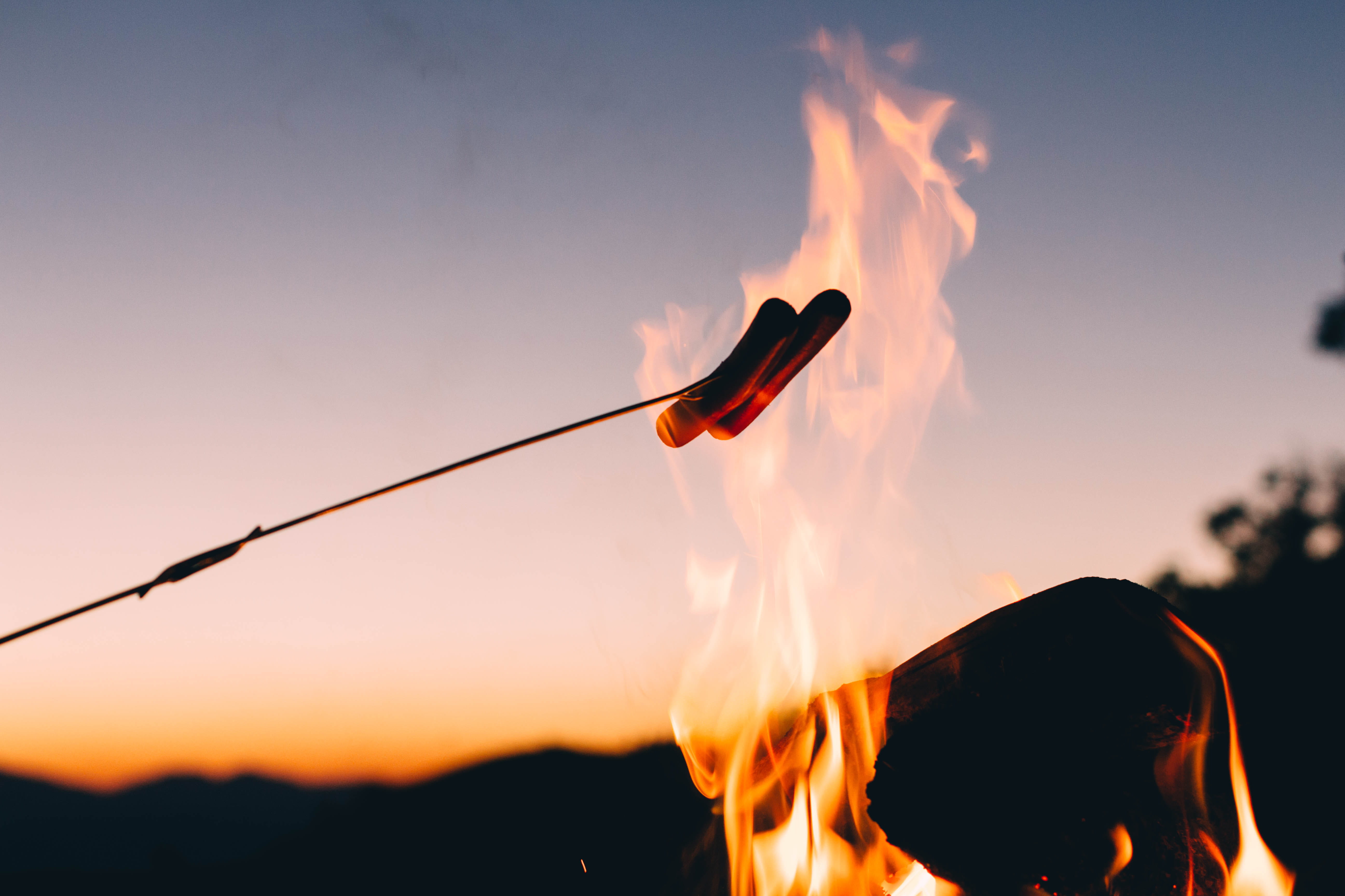 sky, cooking, burning, hot dog, focus on foreground, fire - Natural Phenomenon, holding, orange color, motion, photo, bonfire, hotdogs, young adult, outdoors, HD Wallpaper