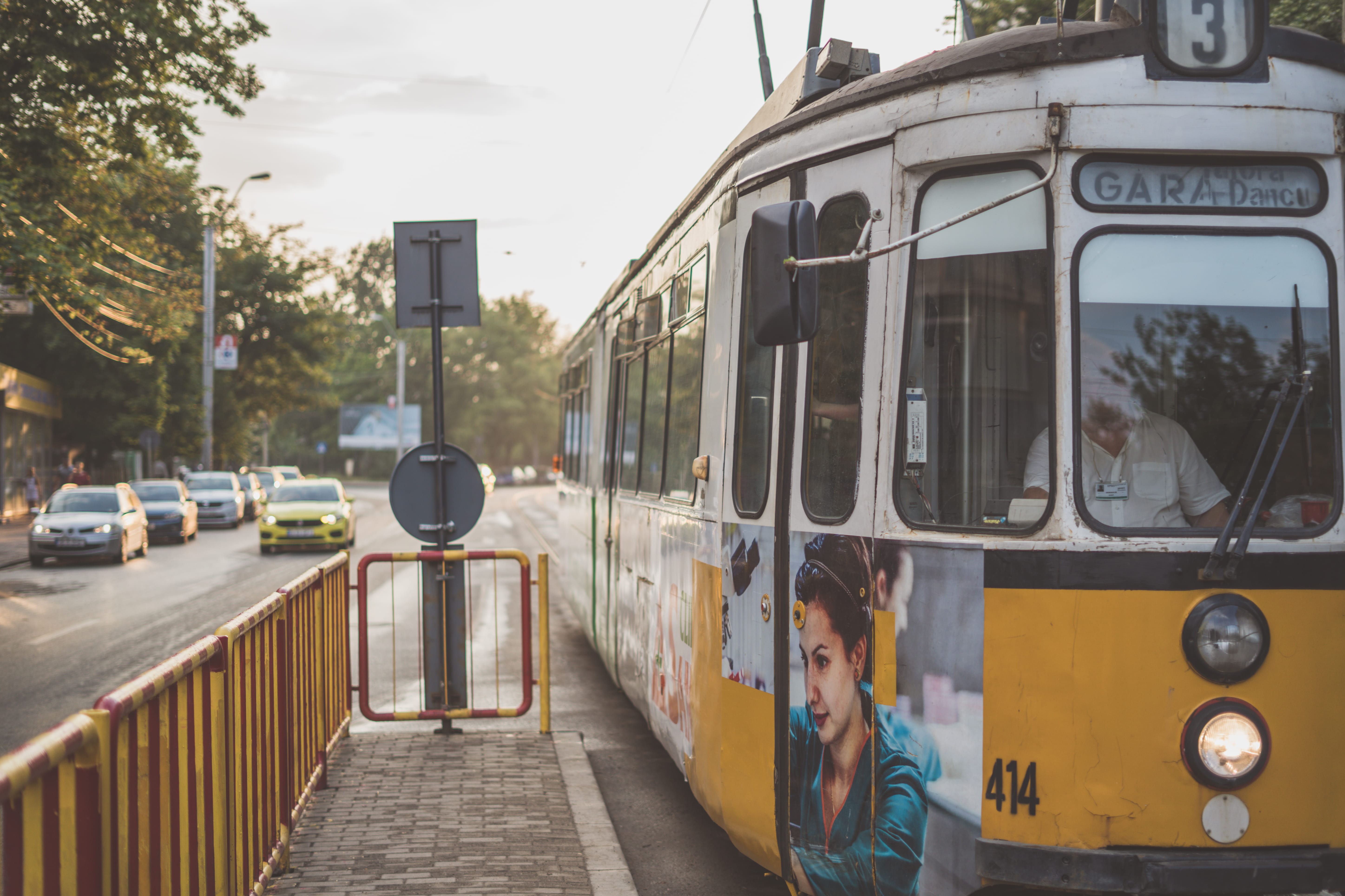 people, nature, romania, yellow, car, city, 5K, motor vehicle, incidental people, fence, tram, iași, vehicle, streetcar, cable car, street, railing, person, HD Wallpaper