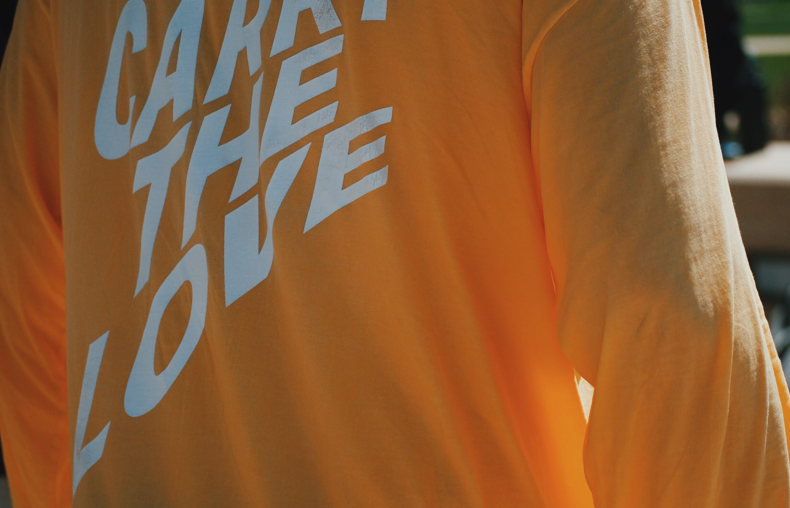 sunlight, human body part, stain, orange color, day, carry the love, standing, one person, rear view, applique, text, calligraphy, indoors, home decor, HD Wallpaper