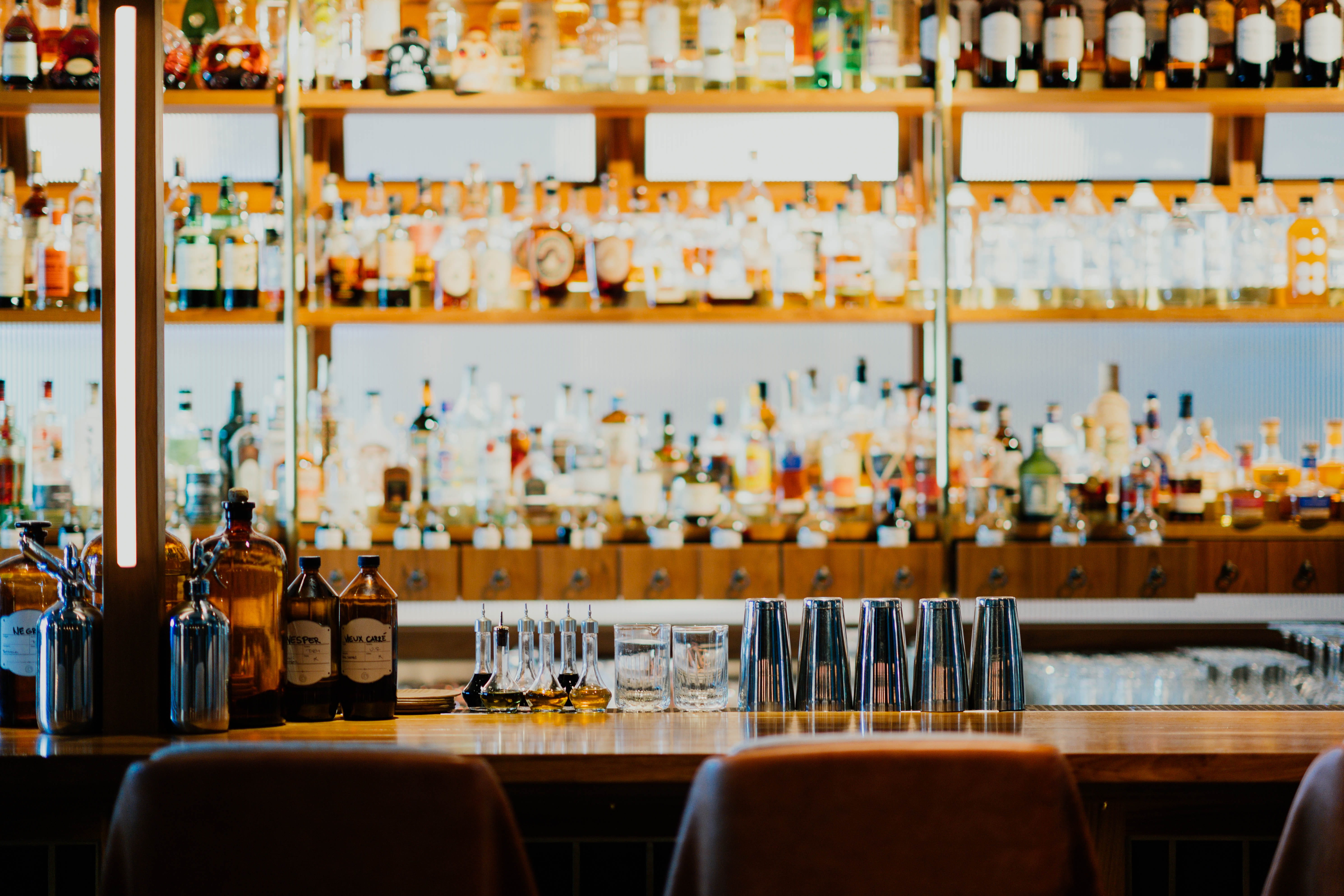 drink, arrangement, container, liquor, abundance, bottle, chair, bartender, beer, side by side, glass - material, business, indoors, person, pub, large group of objects, HD Wallpaper