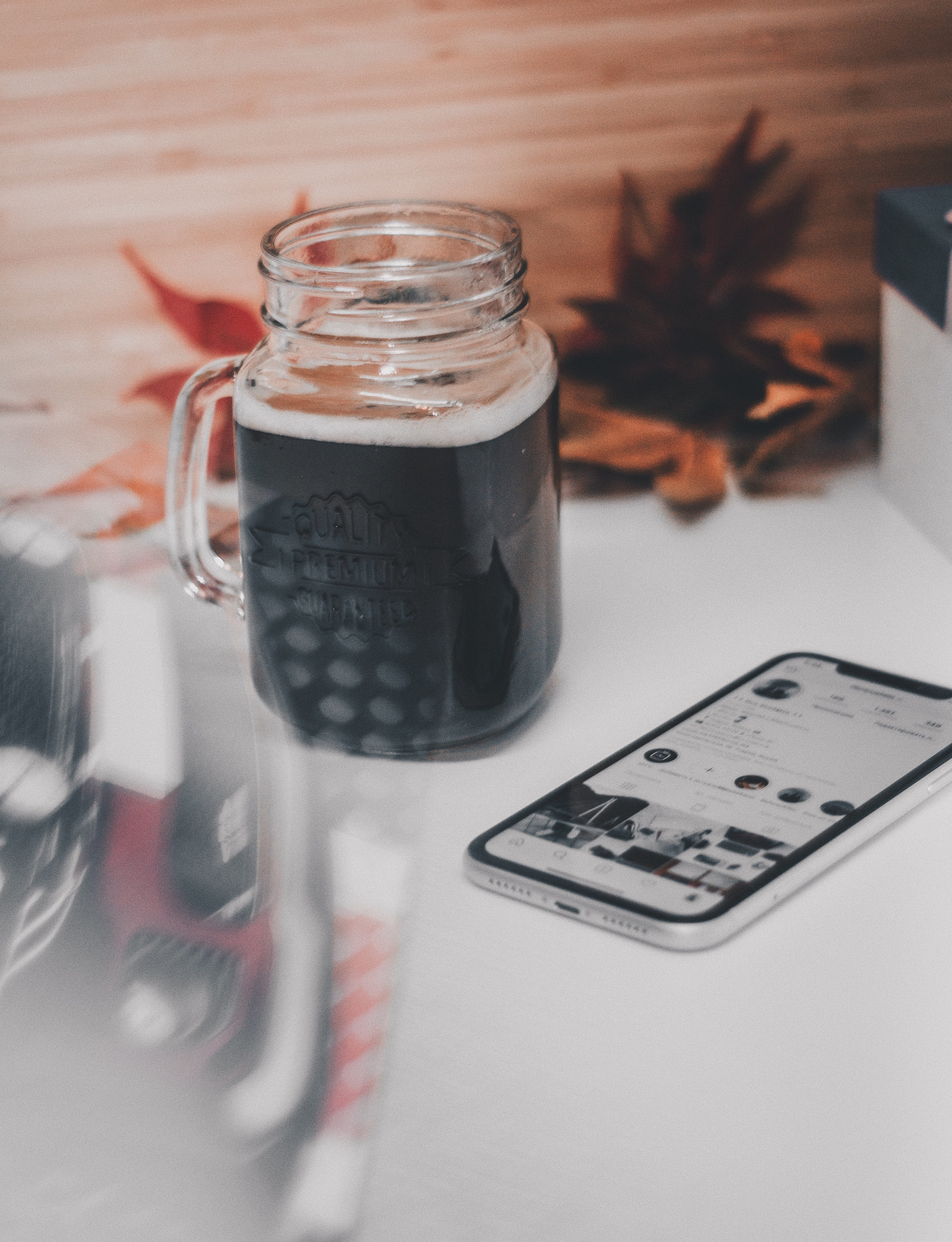 selective focus, photography, table, coca, cup, mug, still life, mason, focus, mobile phone, communication, household equipment, small group of objects, Phone HD Wallpaper