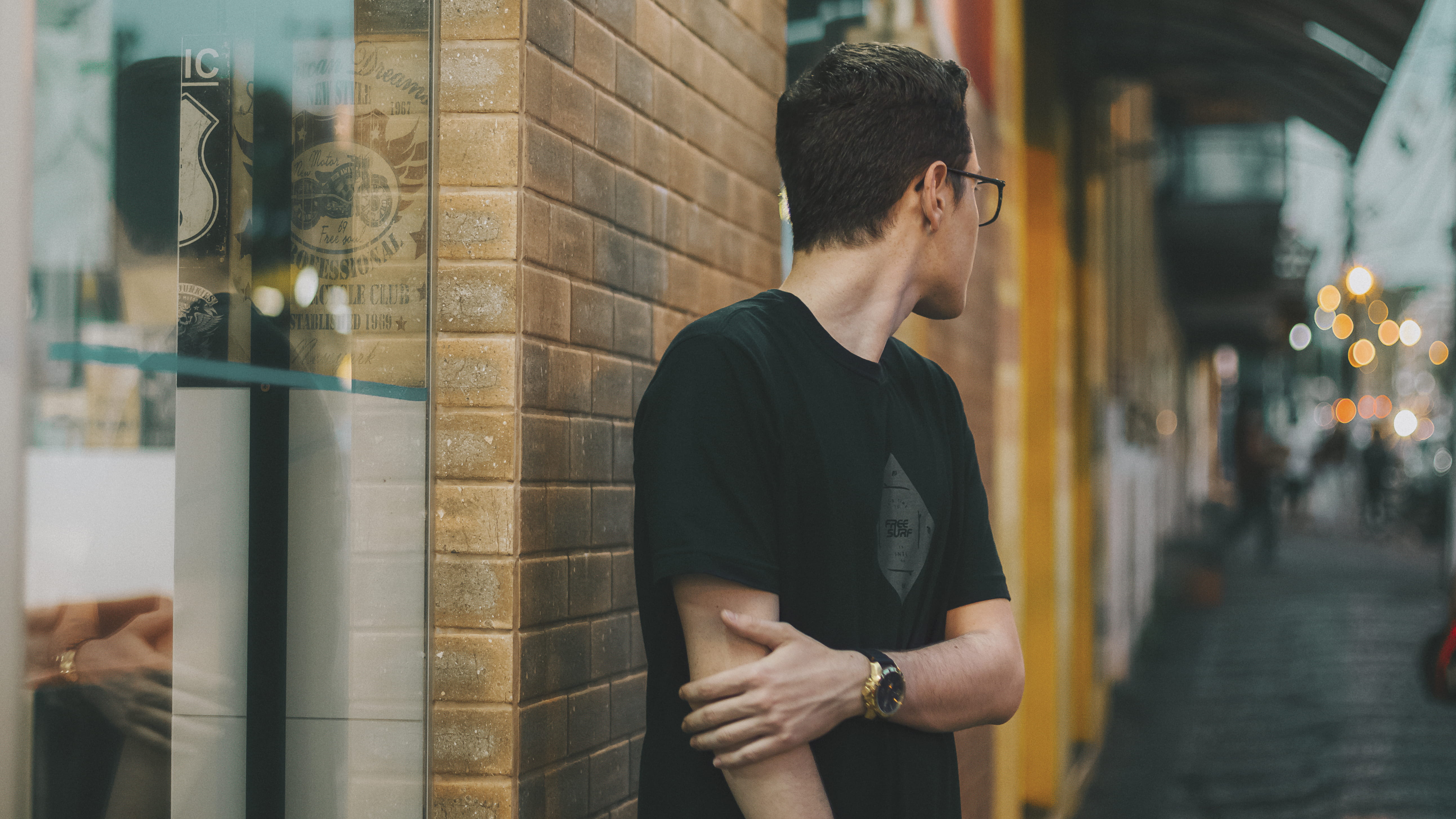 male, wall, pavement, one person, person, young adult, eyewear, reflection, near, black shirt, 5K, focus on foreground, eyeglasses, standing, brick wall, HD Wallpaper