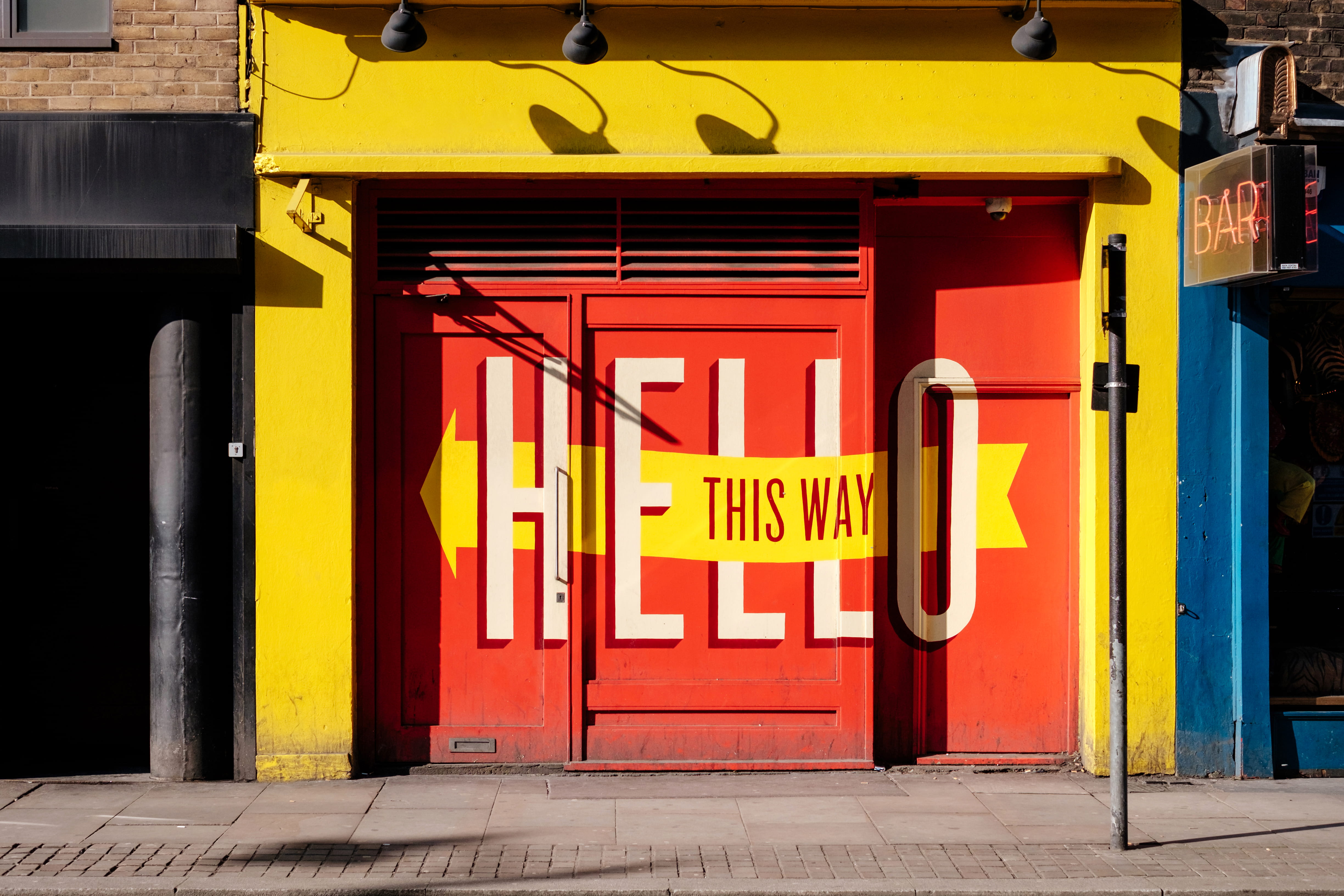 transportation, building exterior, no people, footpath, city, gate, yellow, 4K, architecture, western script, communication, metal, photo, sign, typography, HD Wallpaper