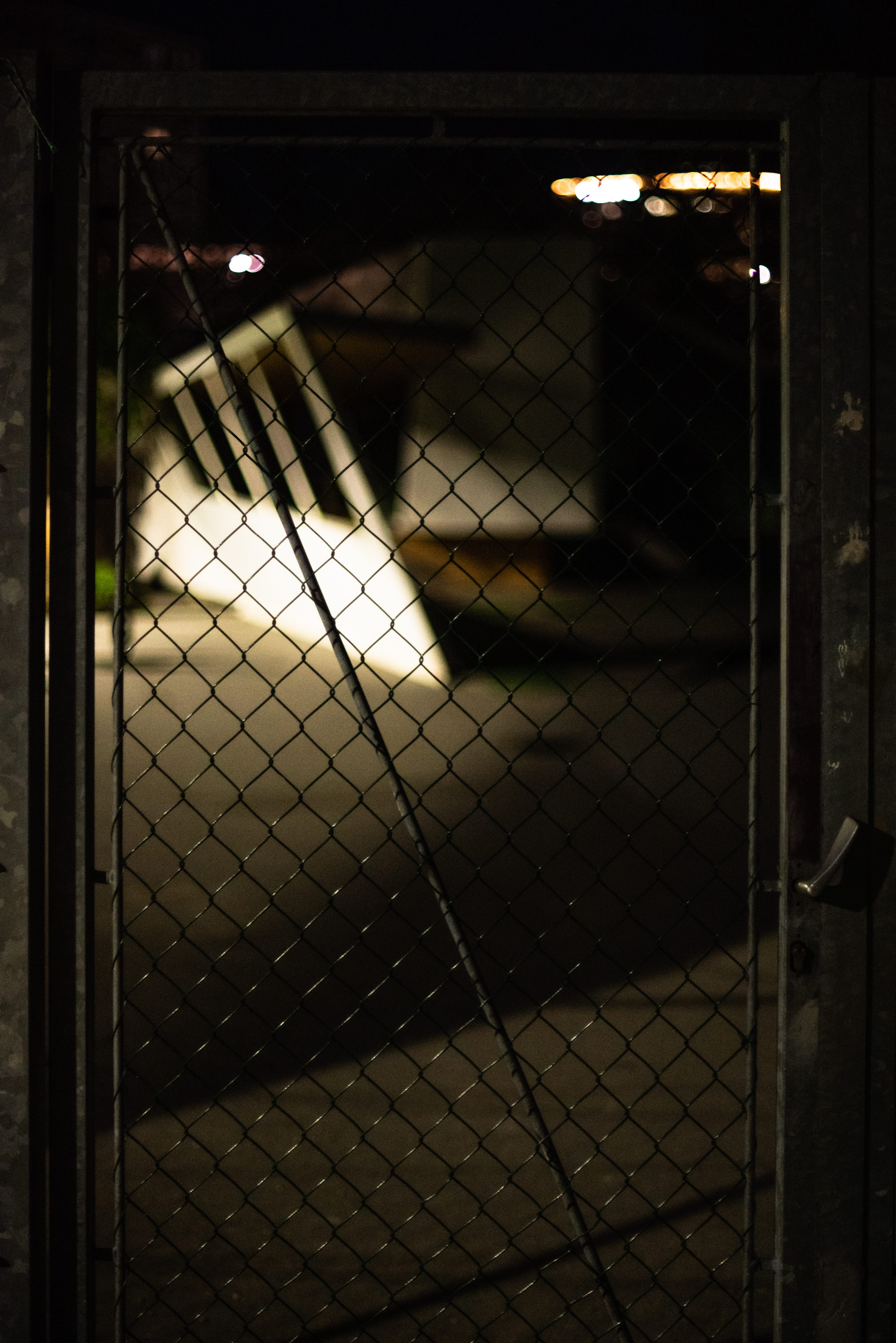 metal, architecture, apparel, furniture, chainlink fence, dungeon, one person, flare, oof, clothing, barrier, banister, highlights, handrail, pattern, focus on foreground, Phone HD Wallpaper