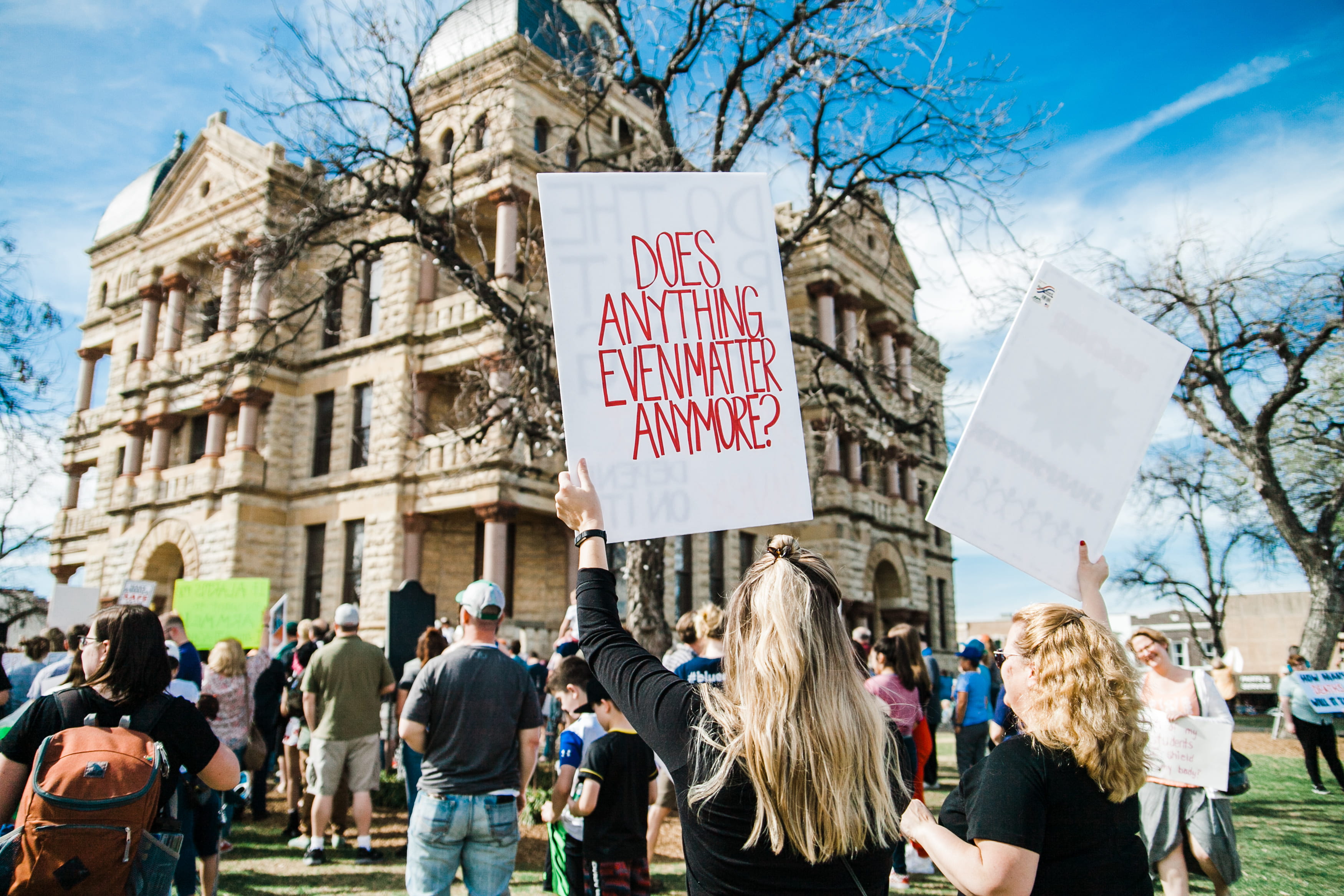 protestor, communication, city, building exterior, nature, woman, message, real people, raising, gun violence, building, person, day, text, print, anything, HD Wallpaper