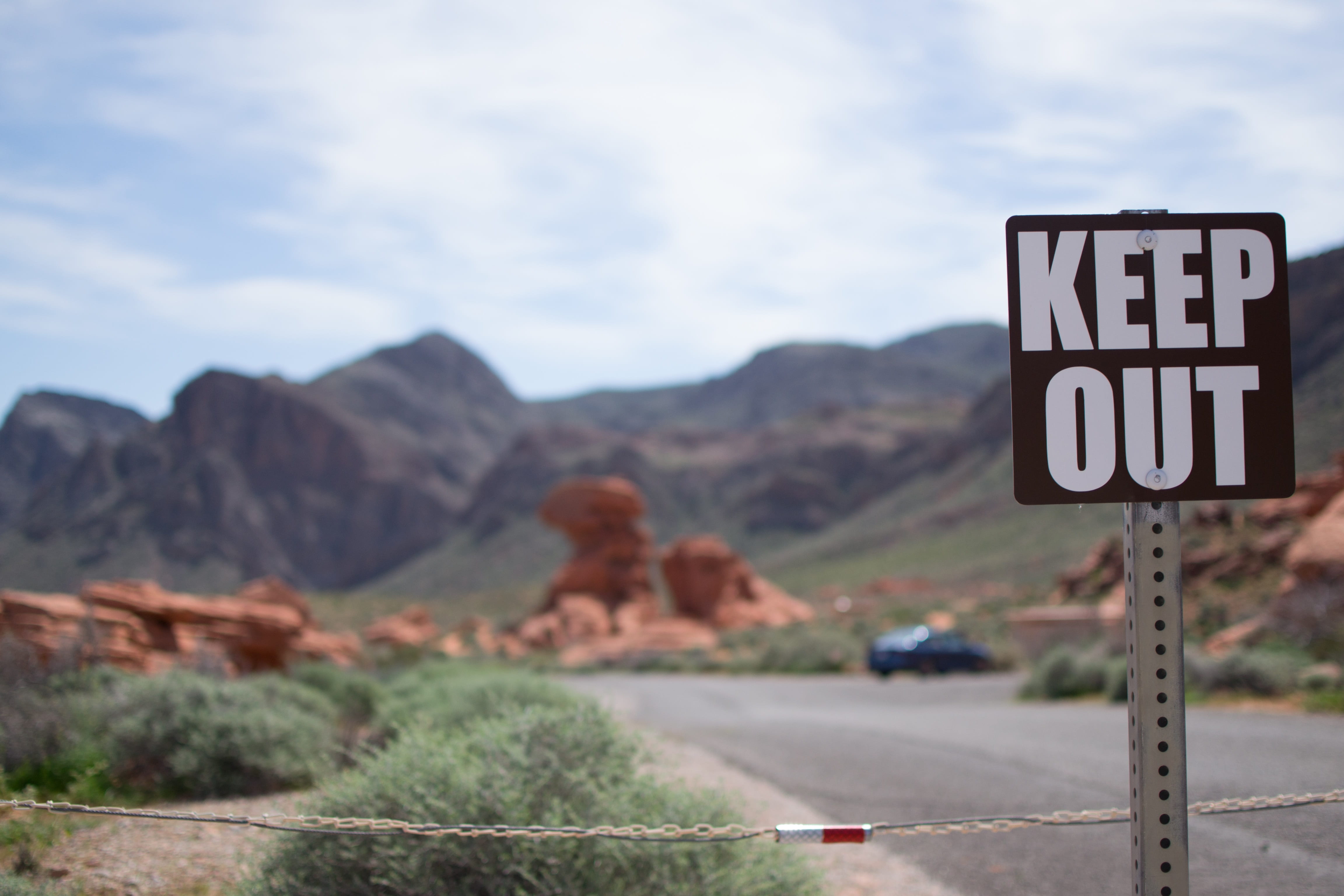 focus on foreground, road sign, rock, road trip, usa, sky, national park, keep out, nevada, shield, text, day, road, landscape, environment, mountain, guidance, HD Wallpaper