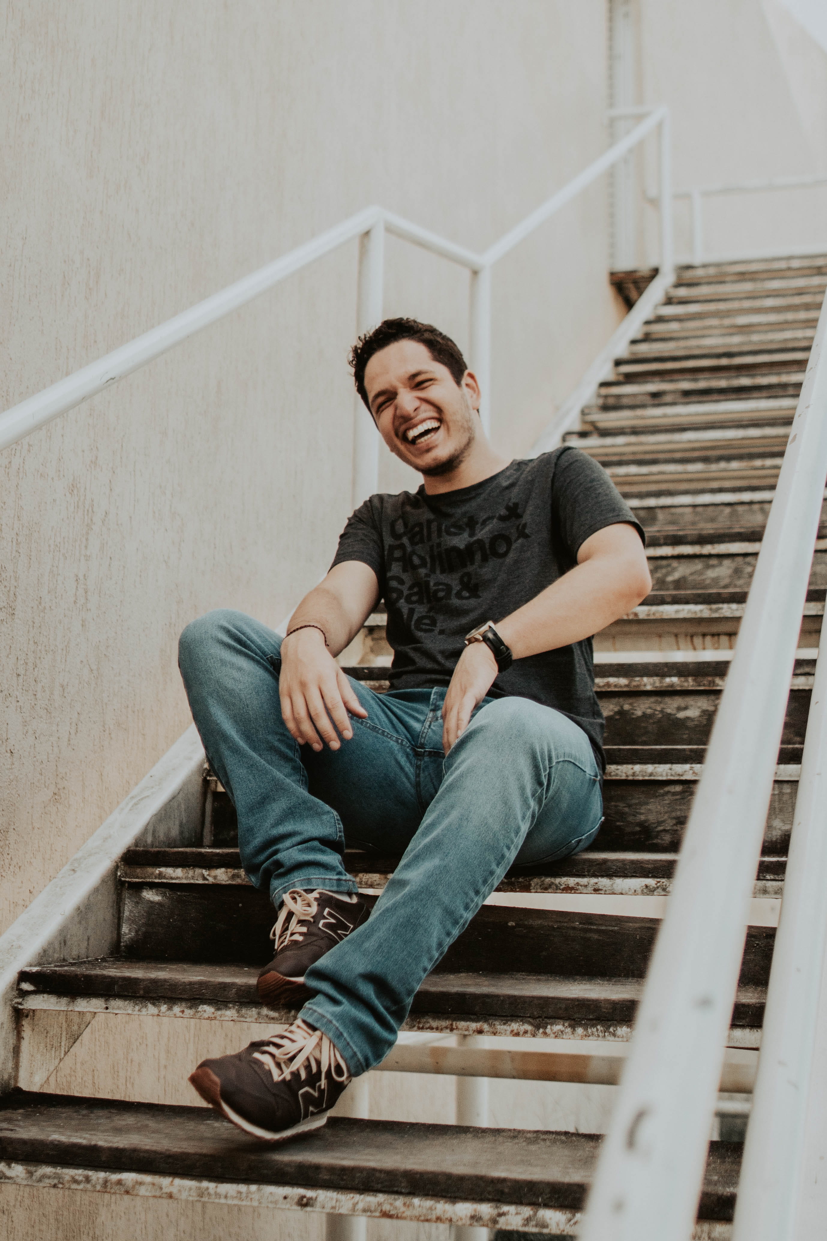 man, 4K, shoe, long sleeve, young men, person, casual clothing, laughing, built structure, railing, clothing, stairs, young adult, emotion, smiling, one person, Phone HD Wallpaper